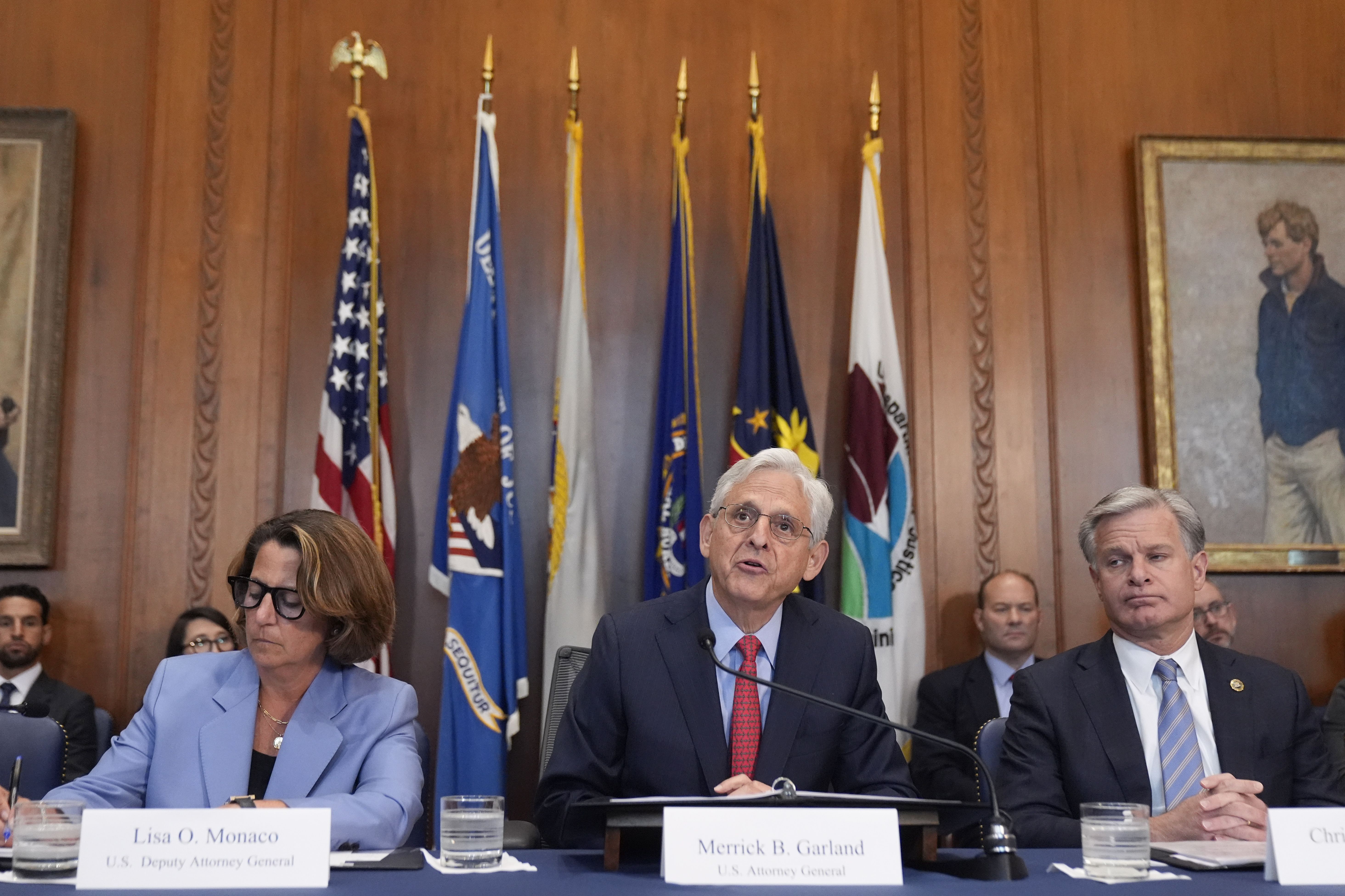 Attorney General Merrick Garland speaks during a meeting of the Justice Department's Election Threats Task Force, at the Department of Justice, Wednesday, Sept. 4, 2024, in Washington, with Deputy Attorney General Lisa Monaco, left, and FBI Director Christopher Wray, right. (AP Photo/Mark Schiefelbe