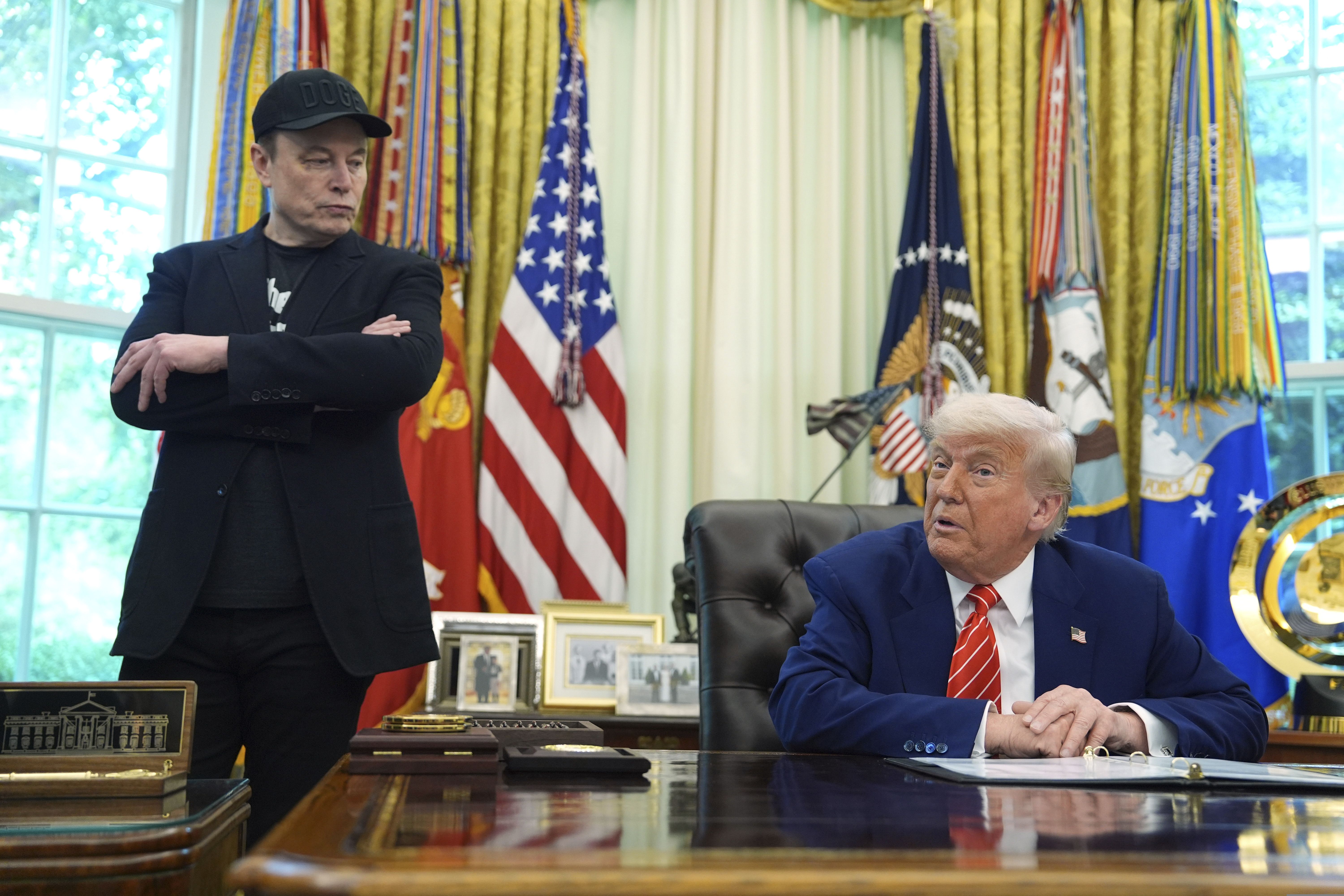 Elon Musk and President Trump speak to reporters in the Oval Office in May.