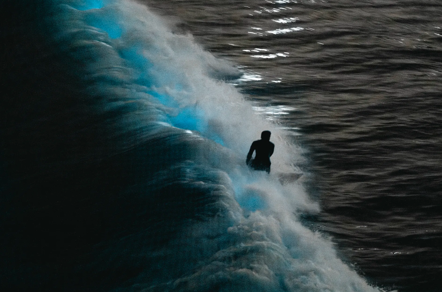 A surfer at night