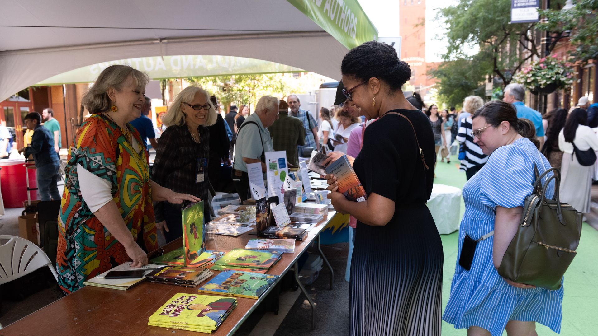 People at a book fair outdoors 