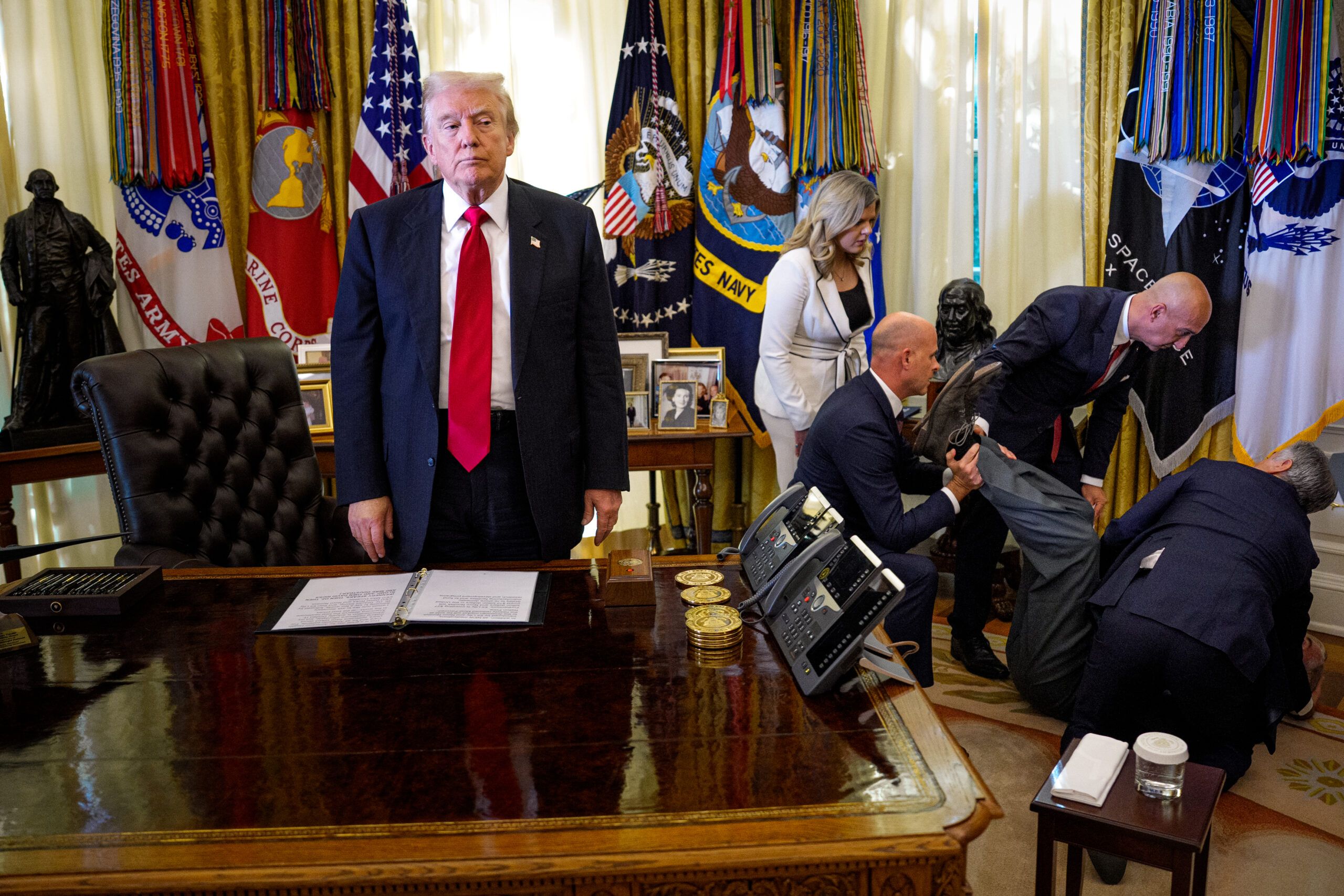 President Trump stands by as attendees help a guest who collapsed during an event on lowering drug prices in the Oval Office in November.