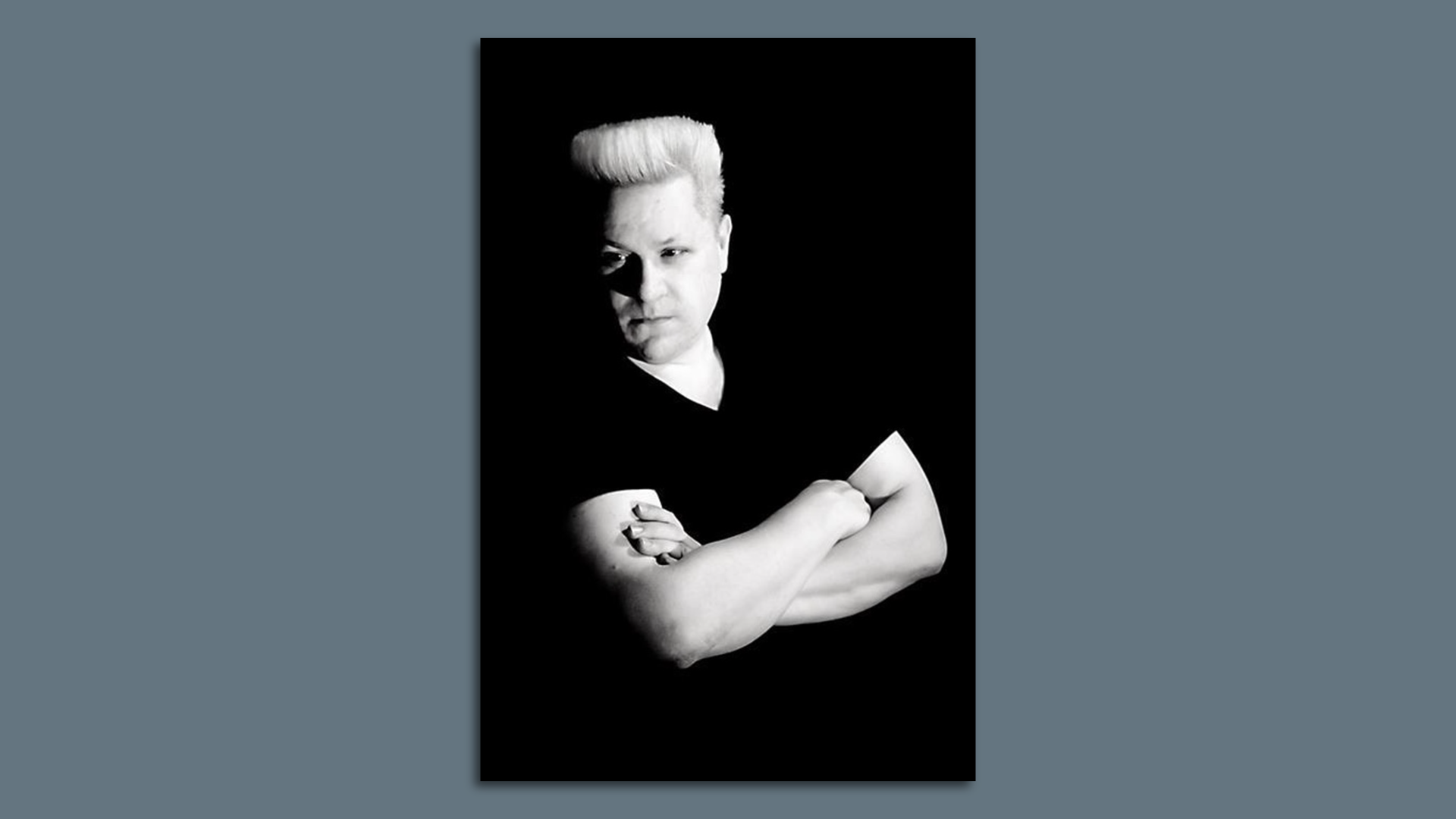 Guy with a flat top and a black t shirt