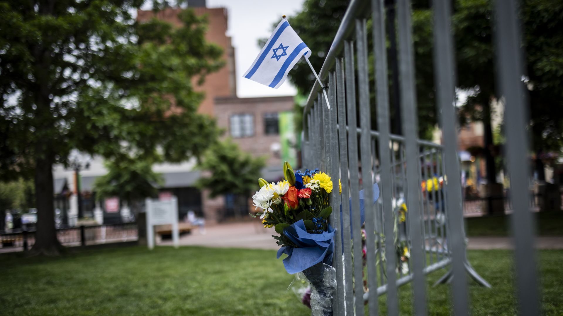 * Flowers and a flag at the site of the attack outside the Boulder County Courthouse on June 2, 2025 in Boulder, Colorado