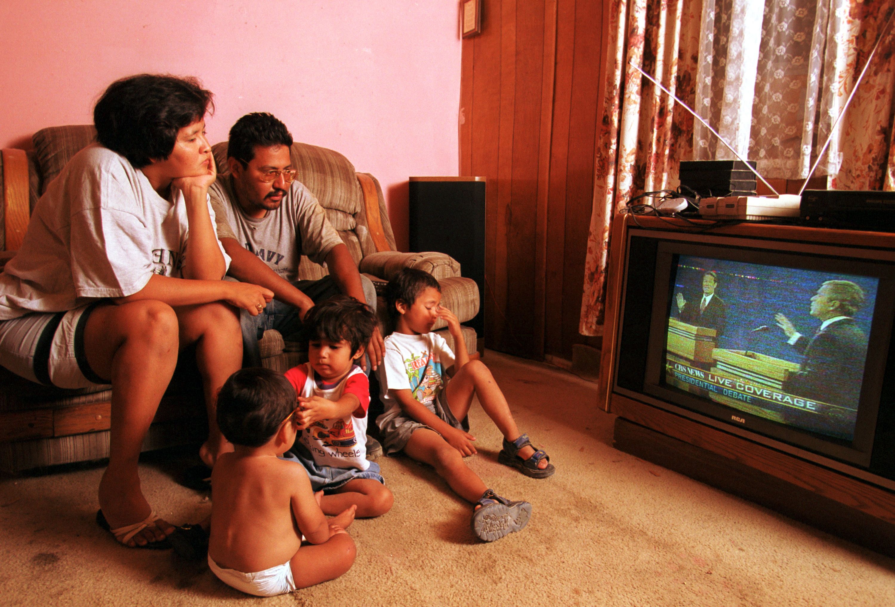 Lorenzo Alvarez, his wife Angelica Alvarez and their three children watch Vice President Al Gore and Texas Gov. George W Bush during the first presidential debate October 3, 2000 at their home in a colonia on the outskirts of El Paso, Texas.