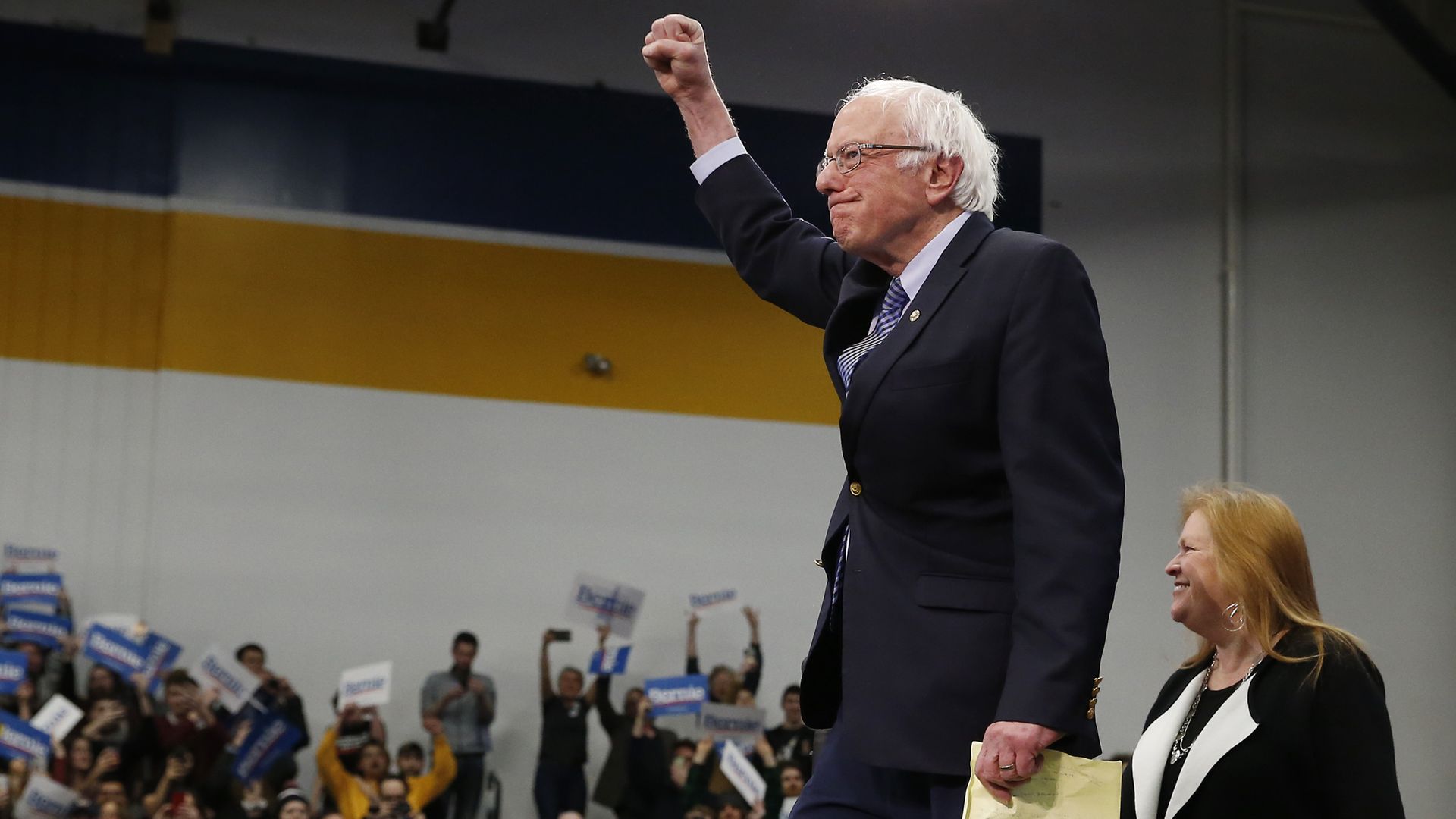 In this image, Bernie stands with a raised fist.