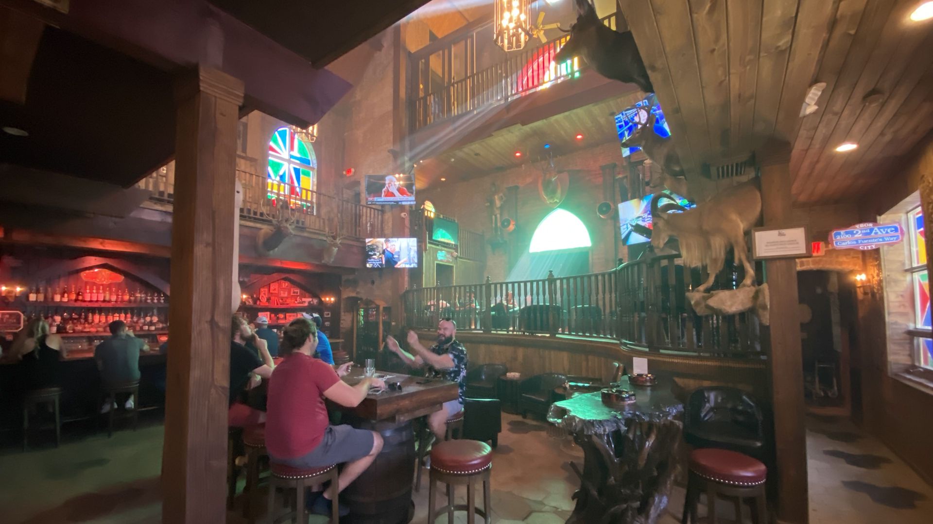 The interior of the Grand Cathedral cigar bar, with people engaged in conversation on barstools.