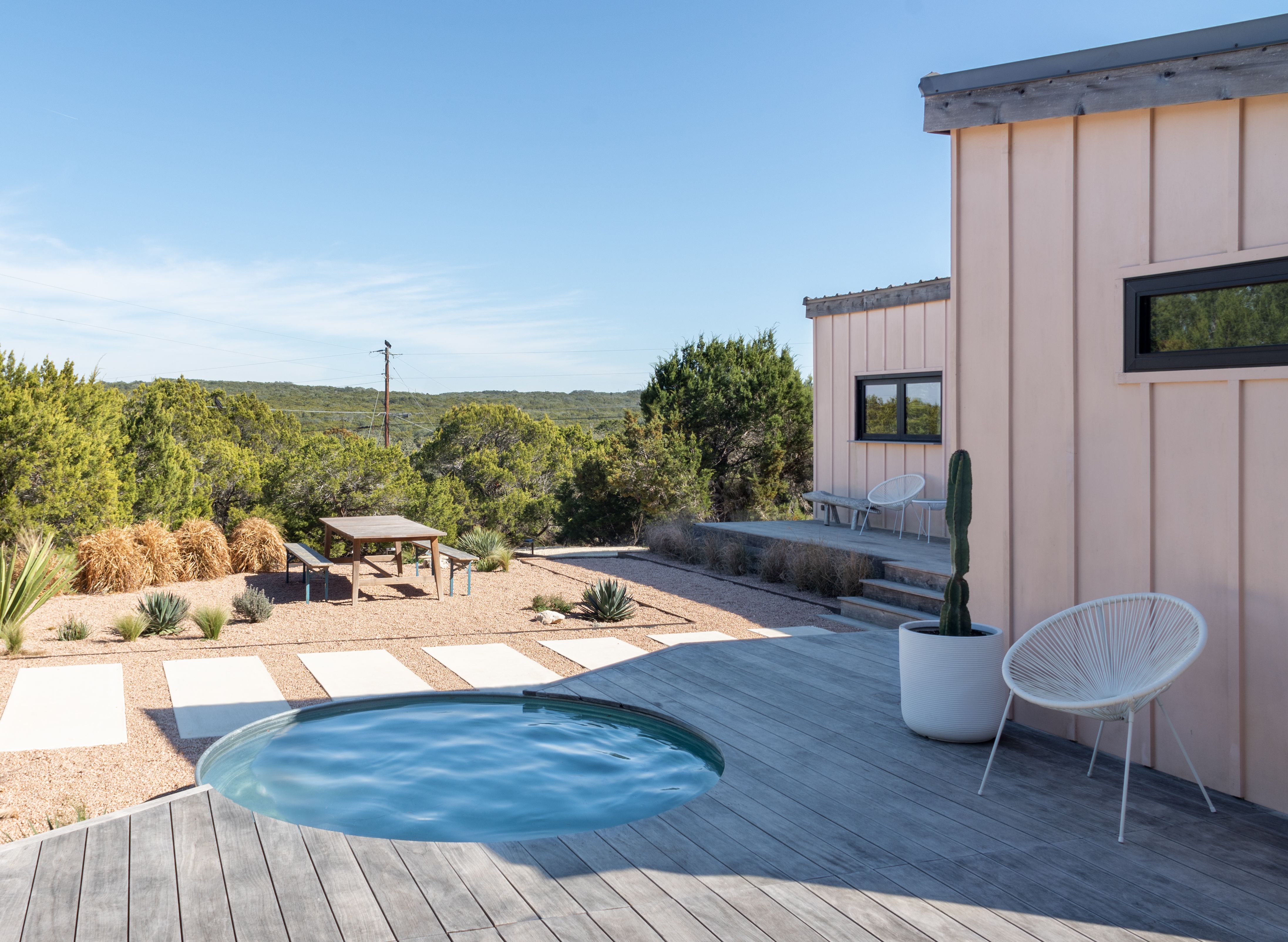 stock tank pool nestled into a deck overlooking nature