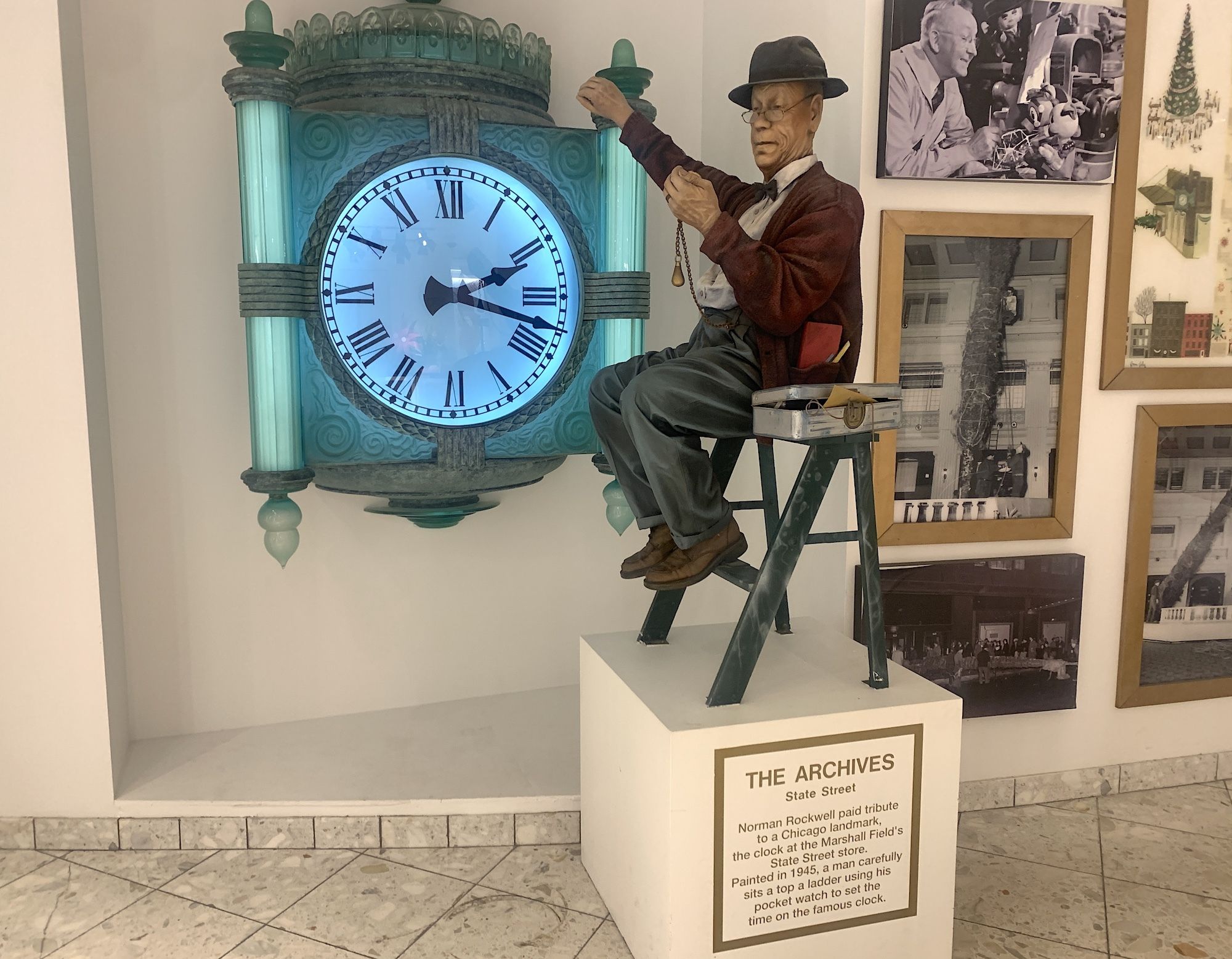 Photo of a puppet working a clock in a museum exhibit. 