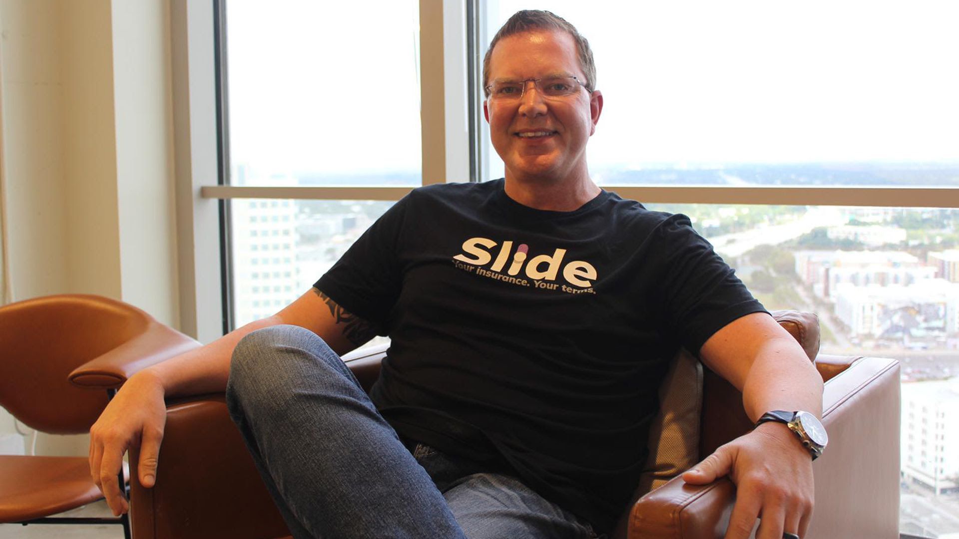 A portrait of Bruce Lucas sitting in a leather chair 