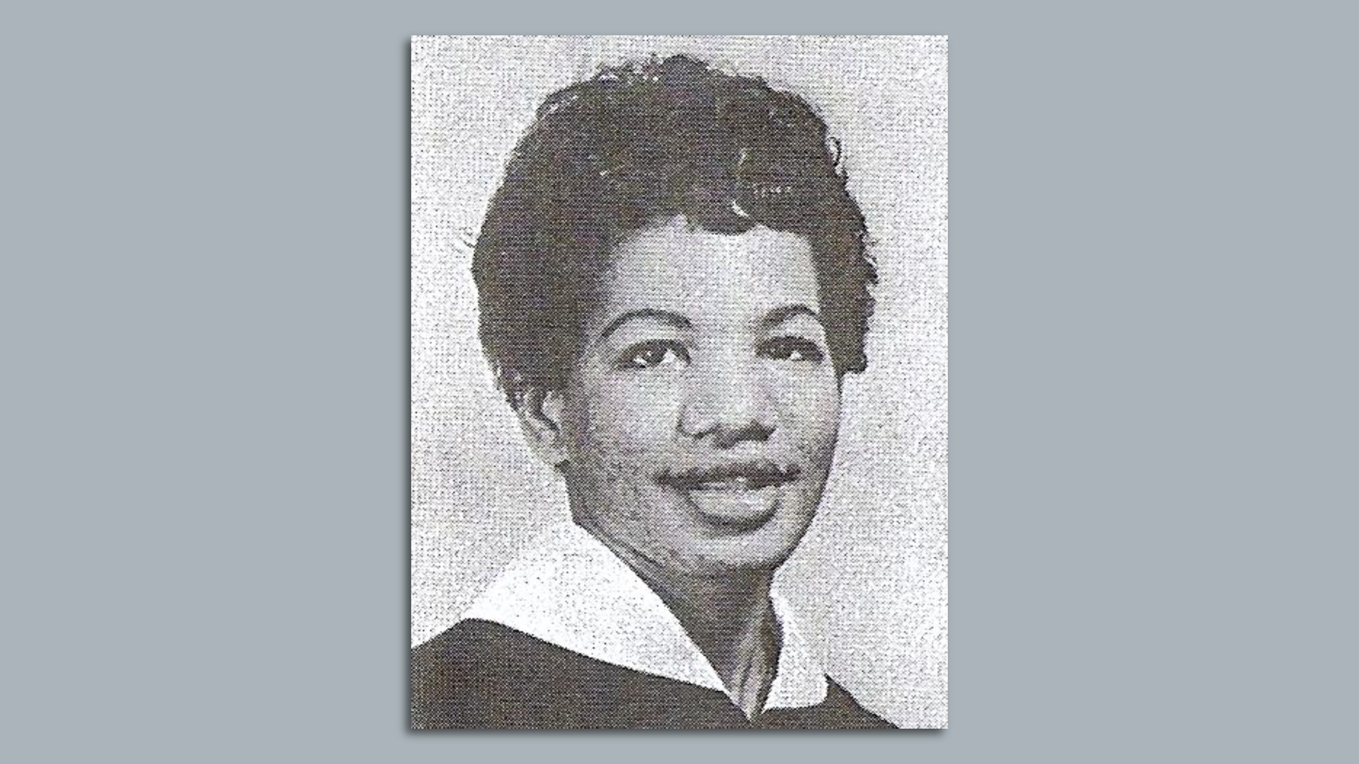 A black-and-white portrait photo of a Ruby Doris Smith-Robinson wearing a large collar and smiling
