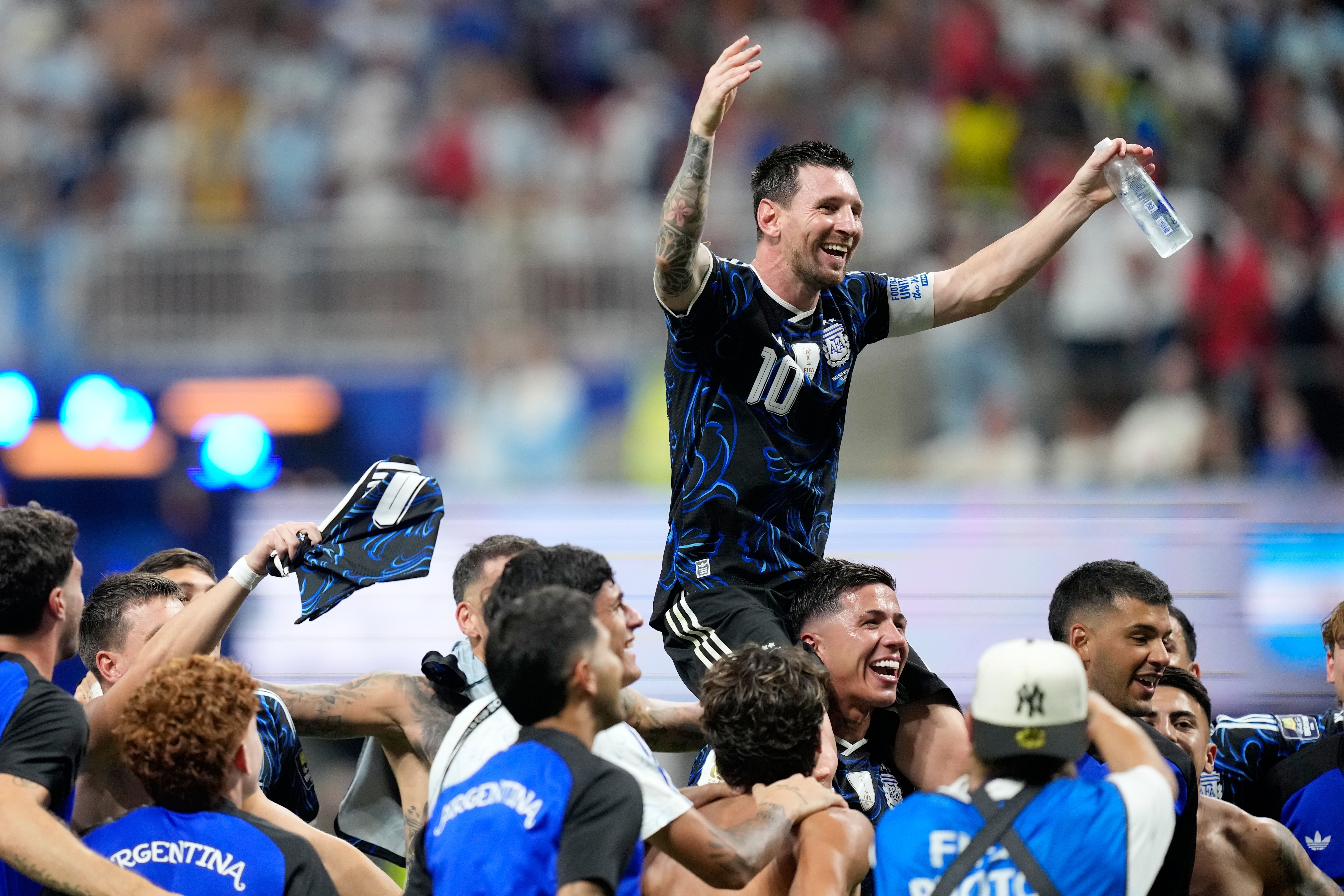 Argentina's Lionel Messi celebrates with his teammates after beating England in Atlanta yesterday.
