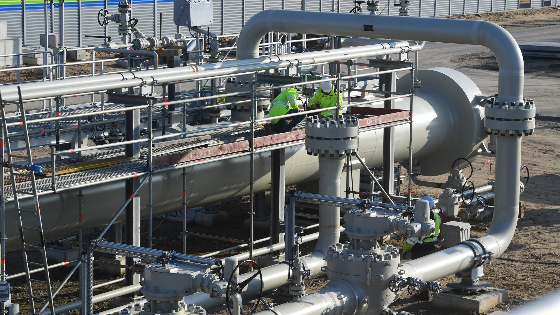 Workers are standing at the construction site of the receiving station of the Nord Stream 2 Baltic Sea pipelin