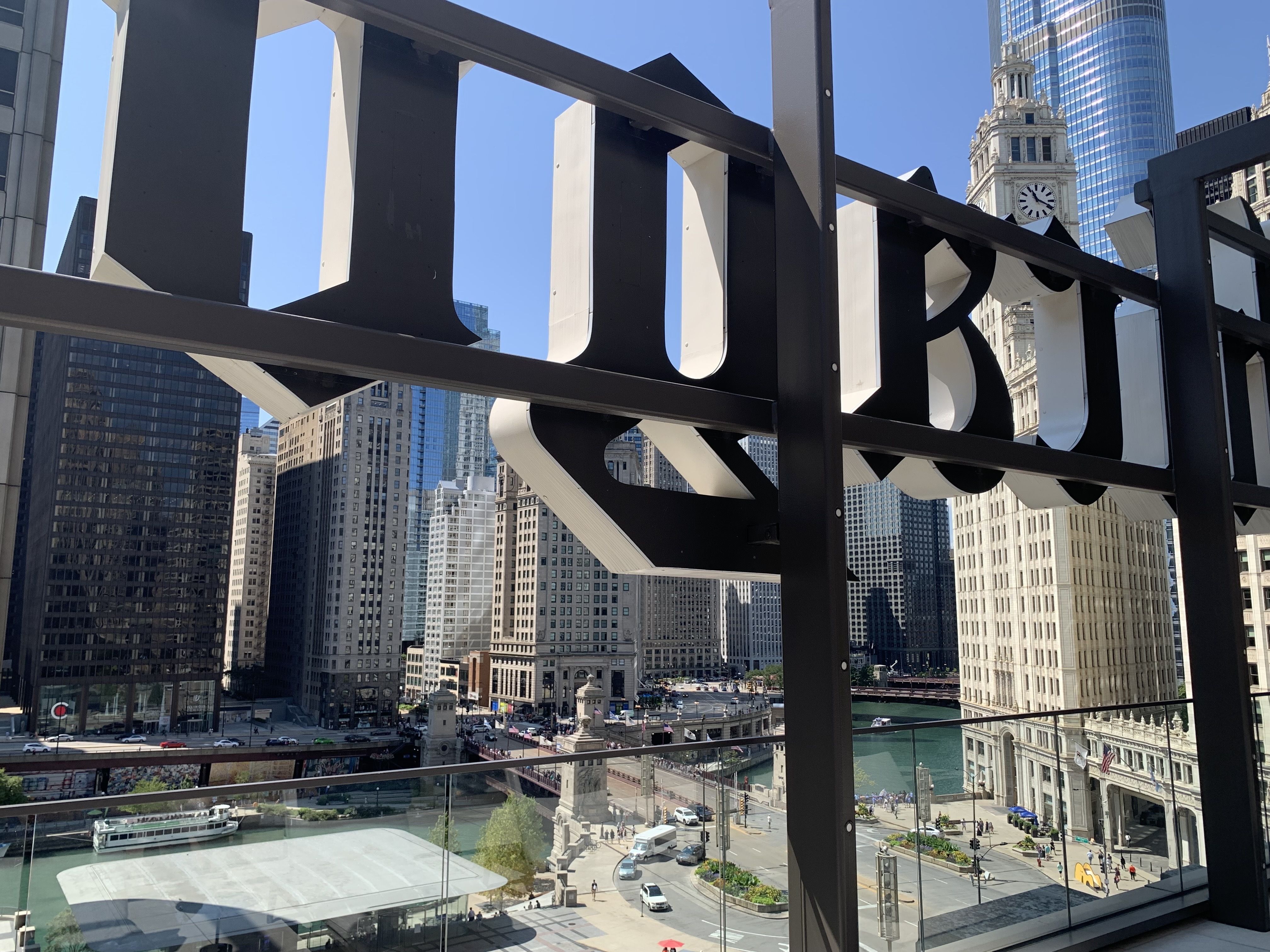 Photo of a skyline partially blocked by a big sign on the side of the building 