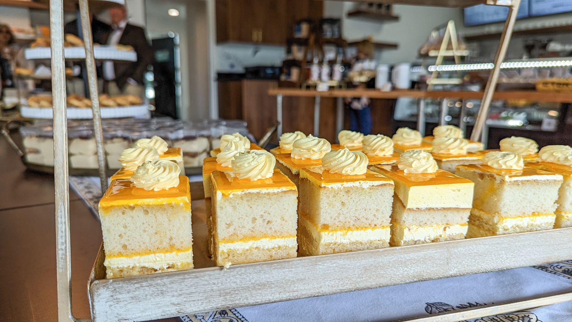 Mango cakes on a wooden serving tray in a bakery. 