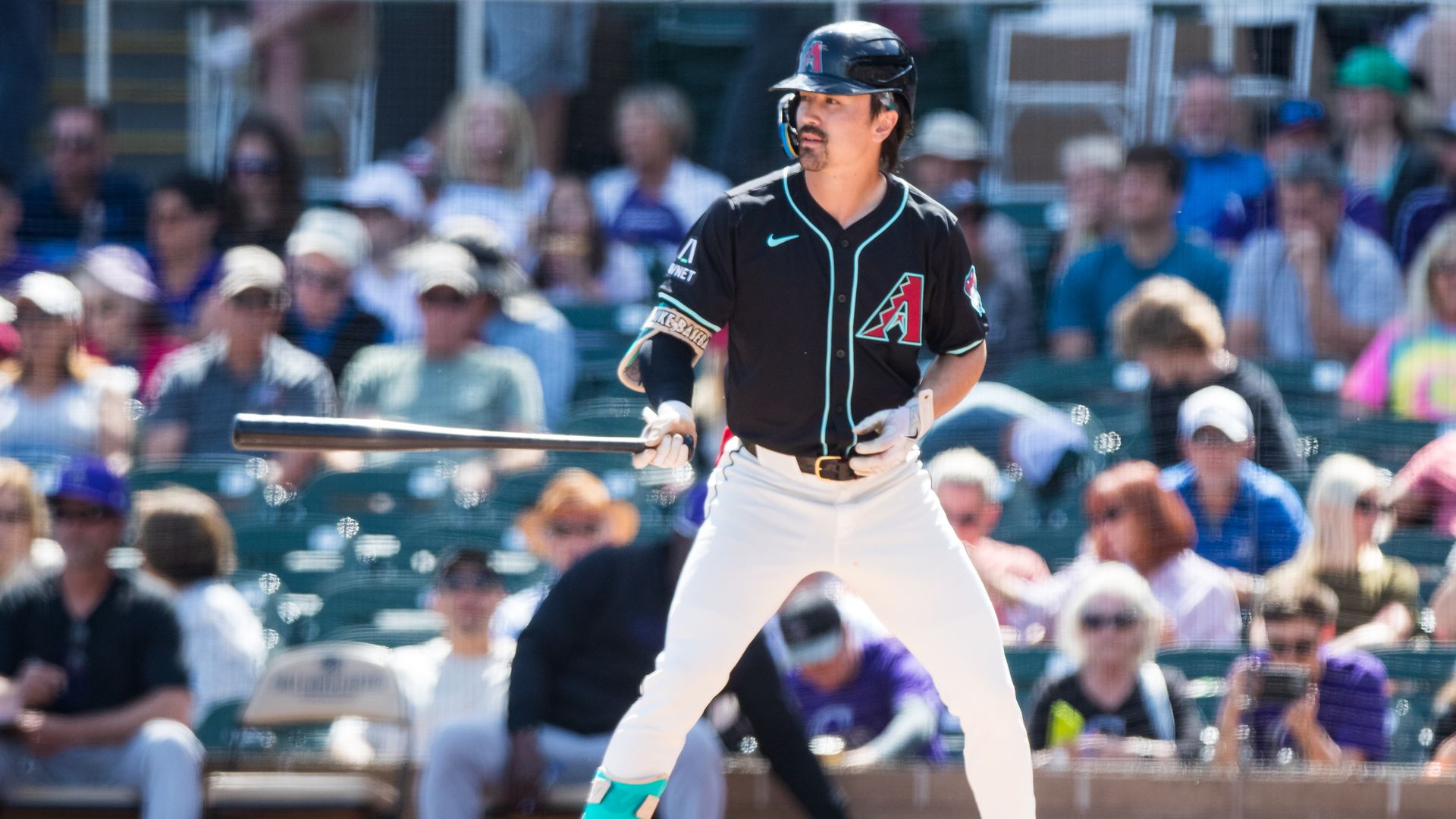 A baseball player prepares to bat. 
