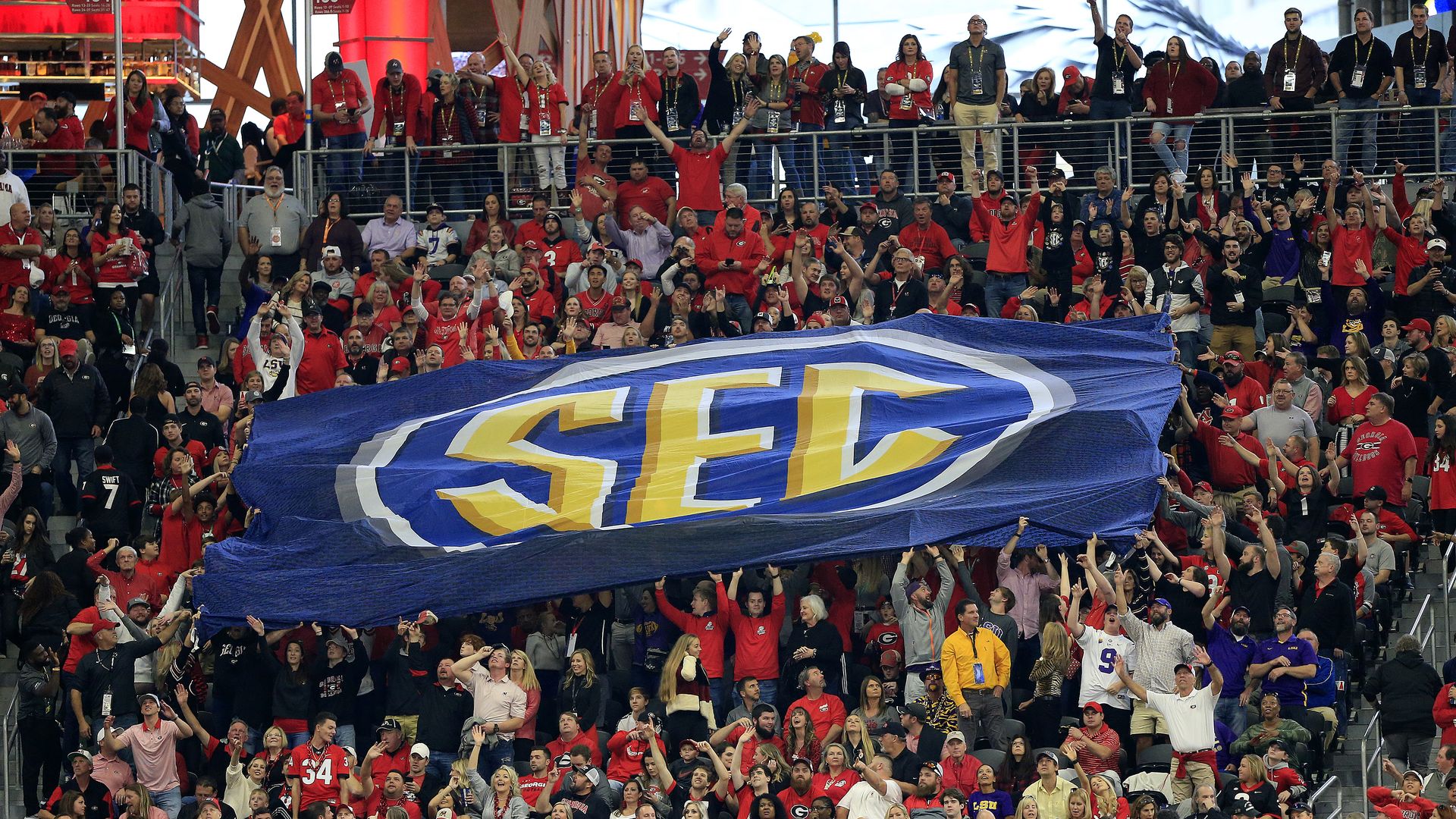 Fans pass along huge SEC banner at football game