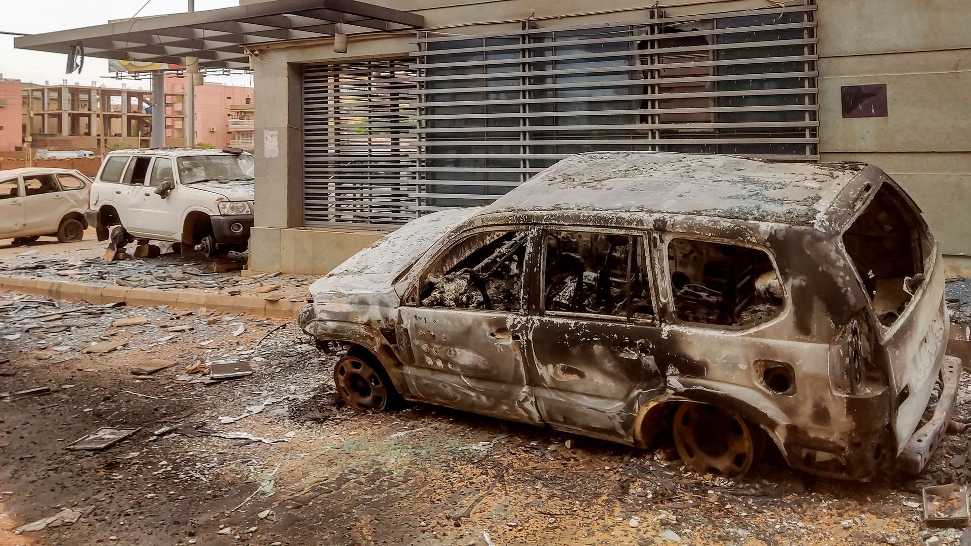 Destroyed vehicles are pictured outside the burnt-down headquarters of Sudan's Central Bureau of Statistics, on al-Sittin (sixty) road in the south of Khartoum