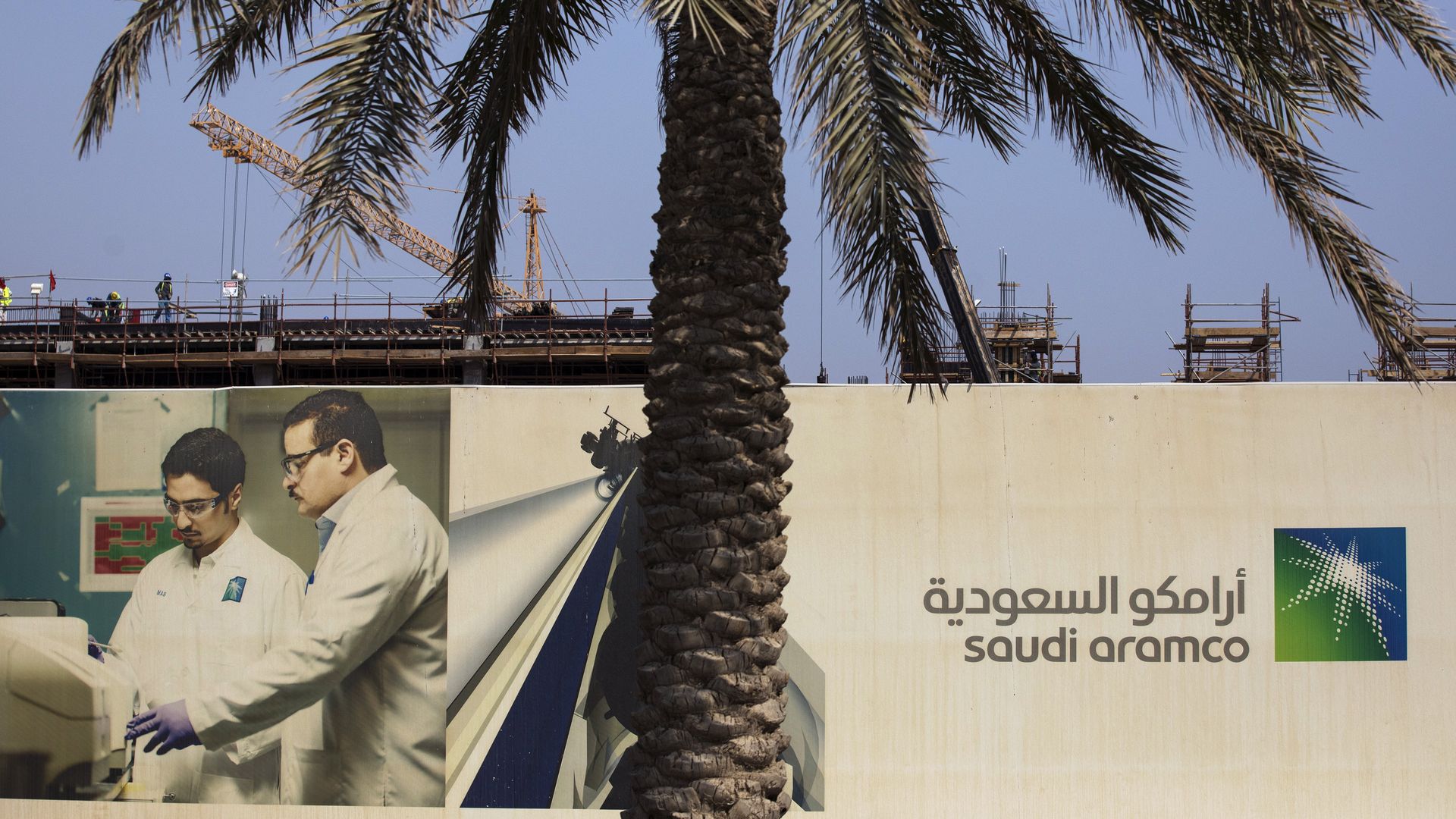 Cranes operate at the construction site of a new building project at the Saudi Aramco oil company's compound in Dhahran, Saudi Arab