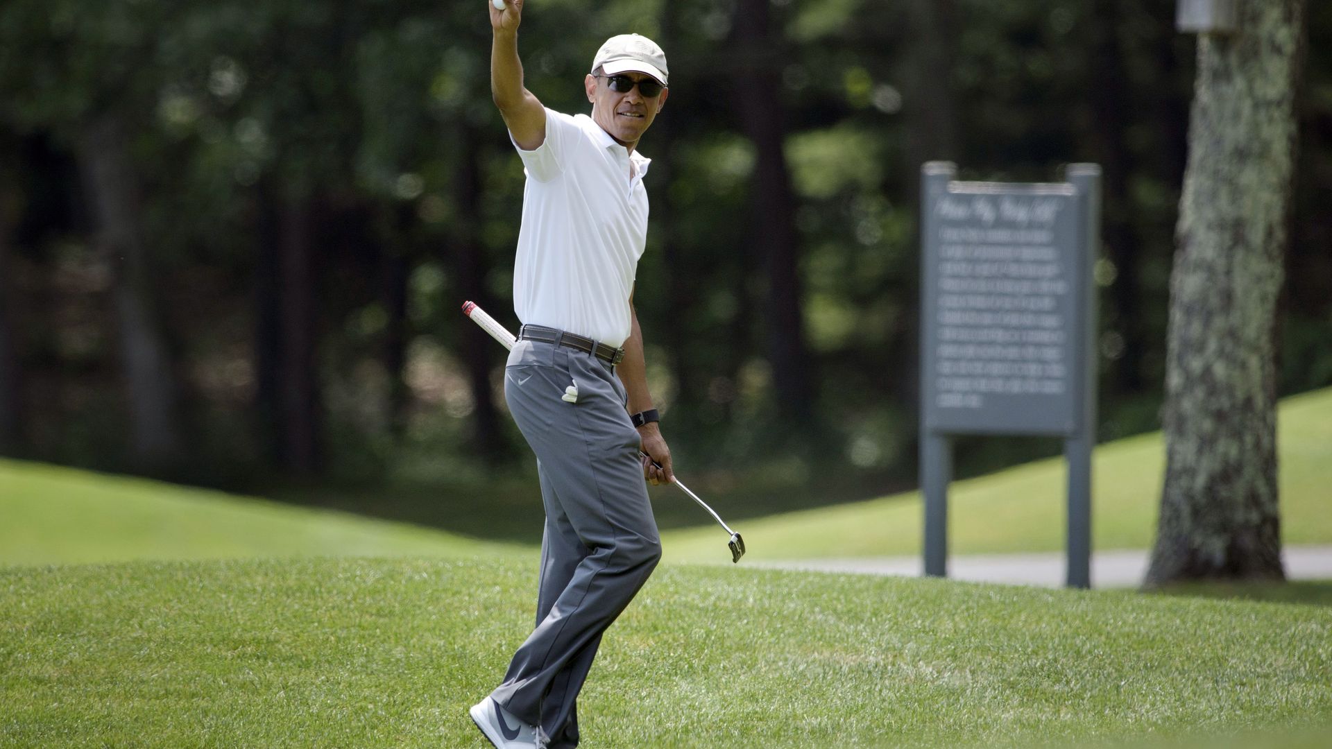 President Obama is seen waving while playing golf on Martha's Vineyard in 2015.
