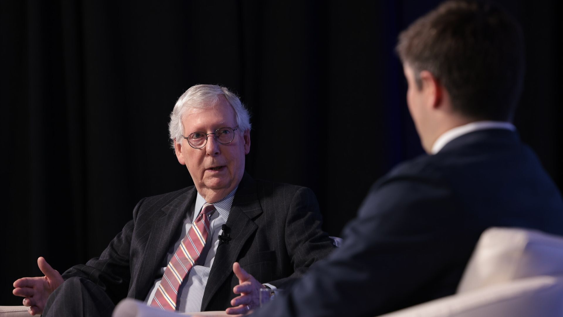 McConnell on stage being interviewed by Jonathan Swan