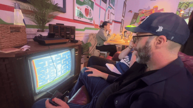 GIF of a man playing video games on an old TV 