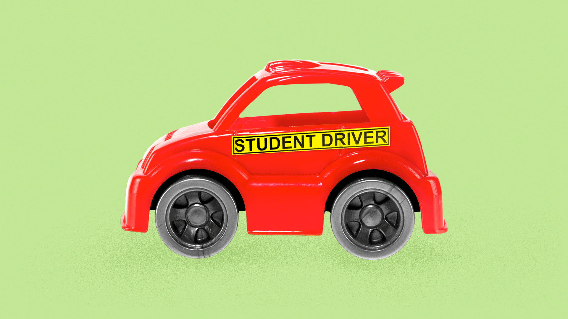 Illustration of a toy car with a "Student Driver" sticker across the side. 