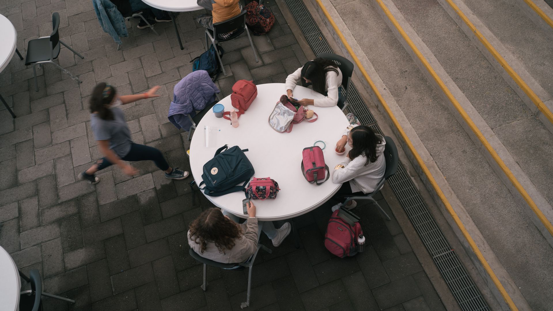 Students eat lunch outside at a private high school on the first day of classes in Mexico City, Mexico, on Monday, Aug. 30, 2021.