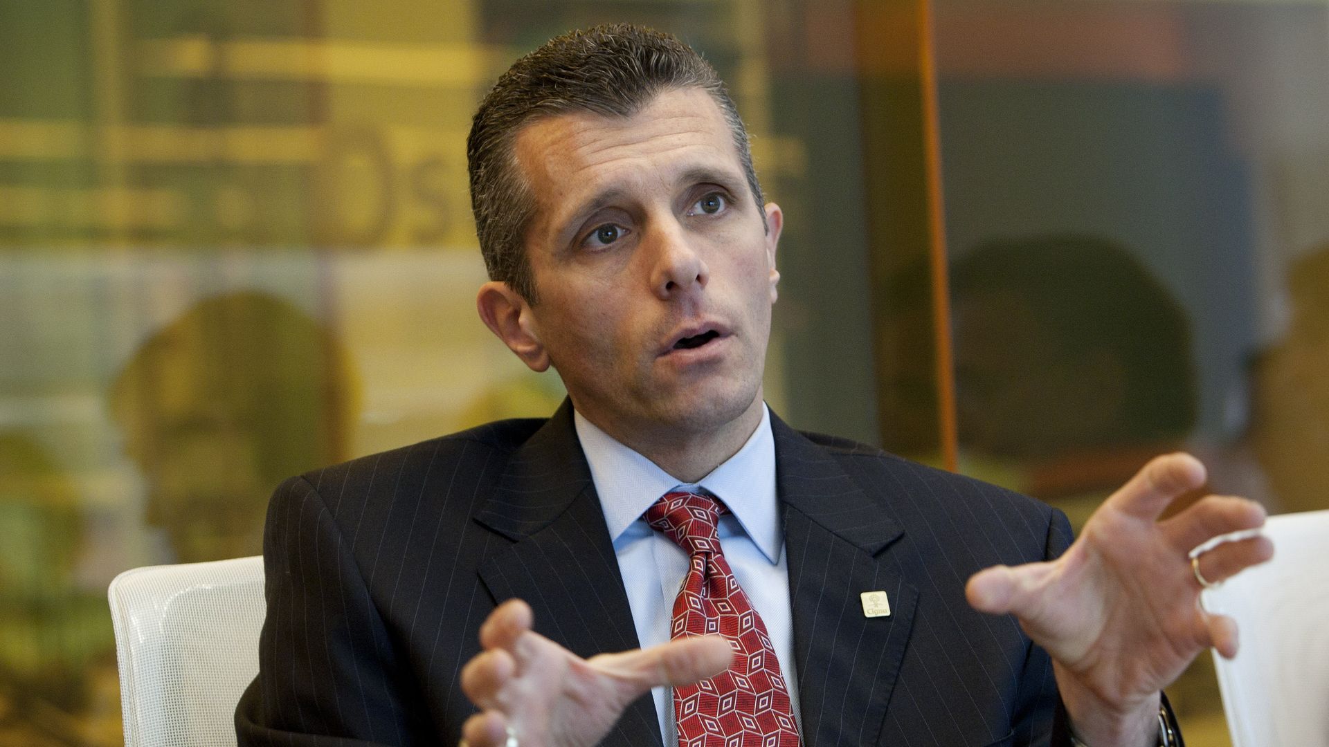 Cigna CEO David Cordani talks in a board room.