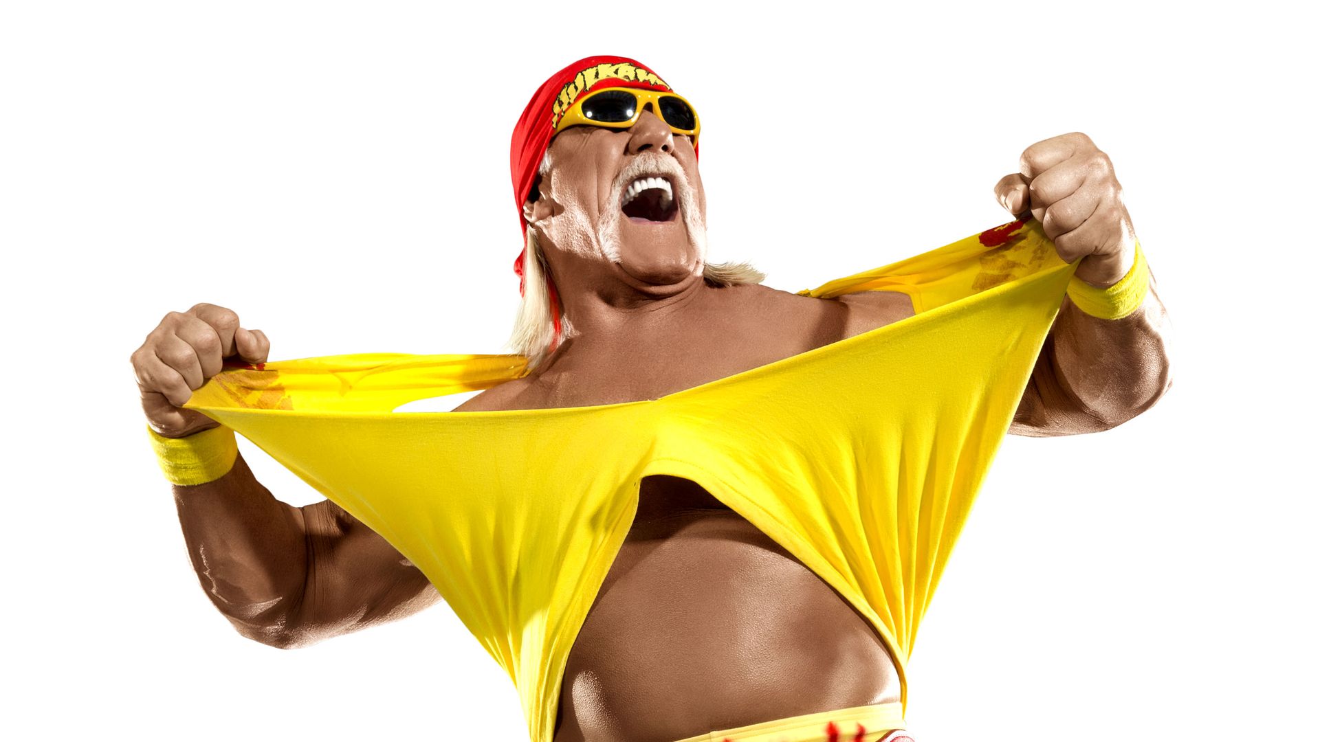 Hulk Hogan rips open his yellow shirt.