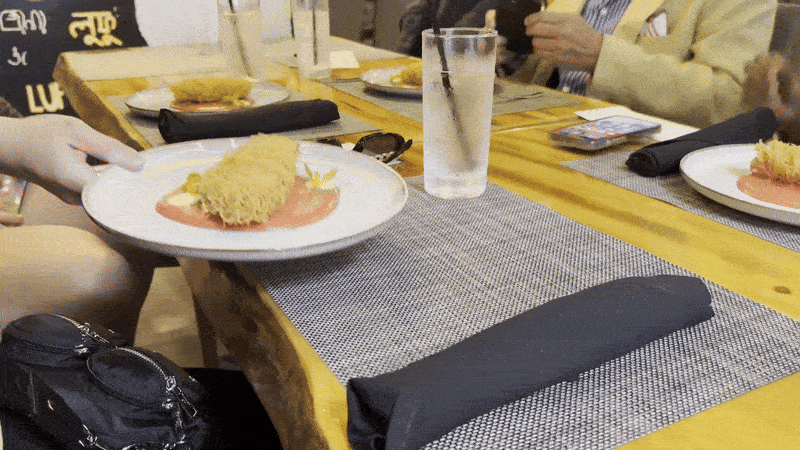 A dish is served onto a table.