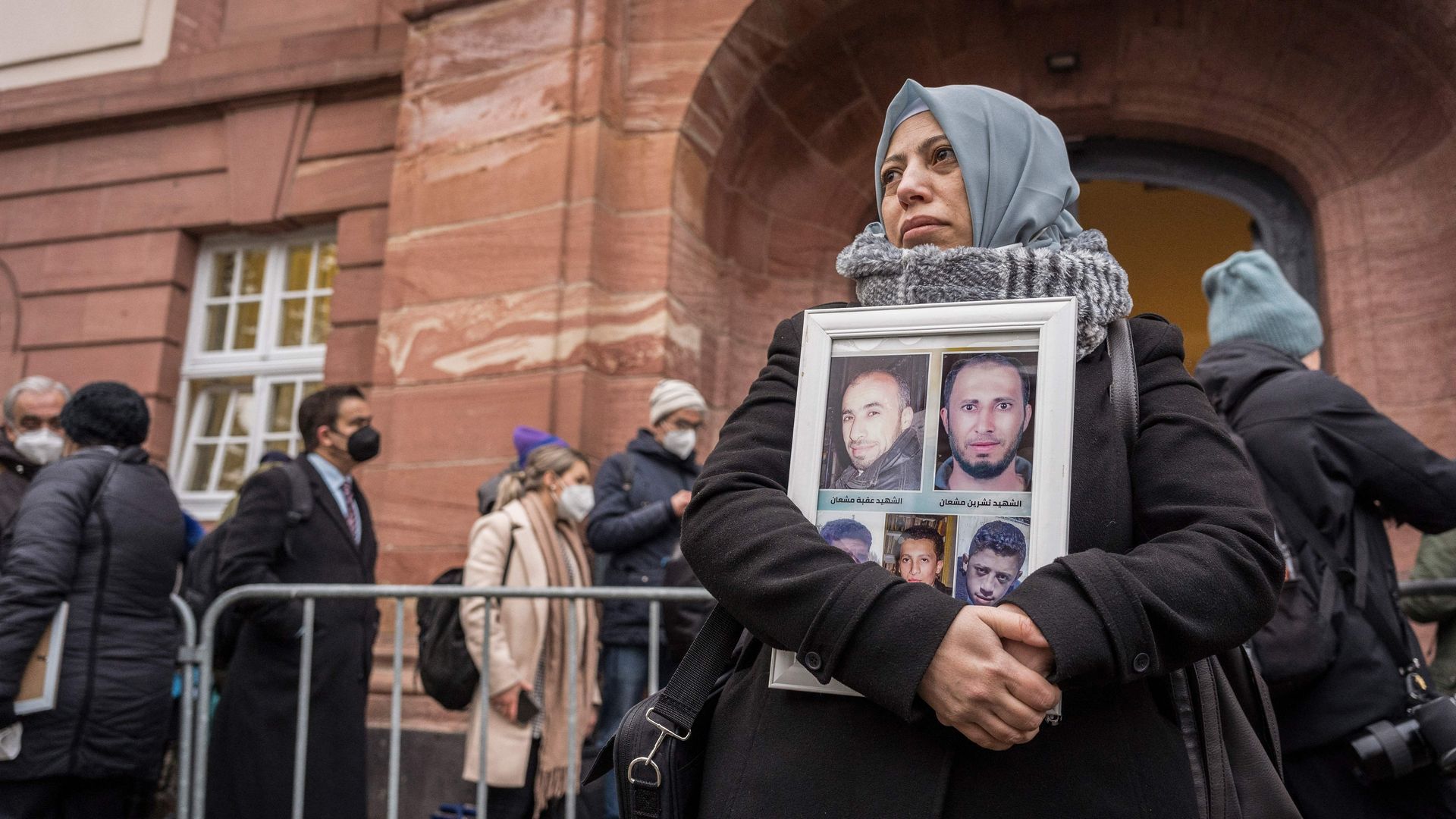 Campaigner holds picture of Syrian war victims