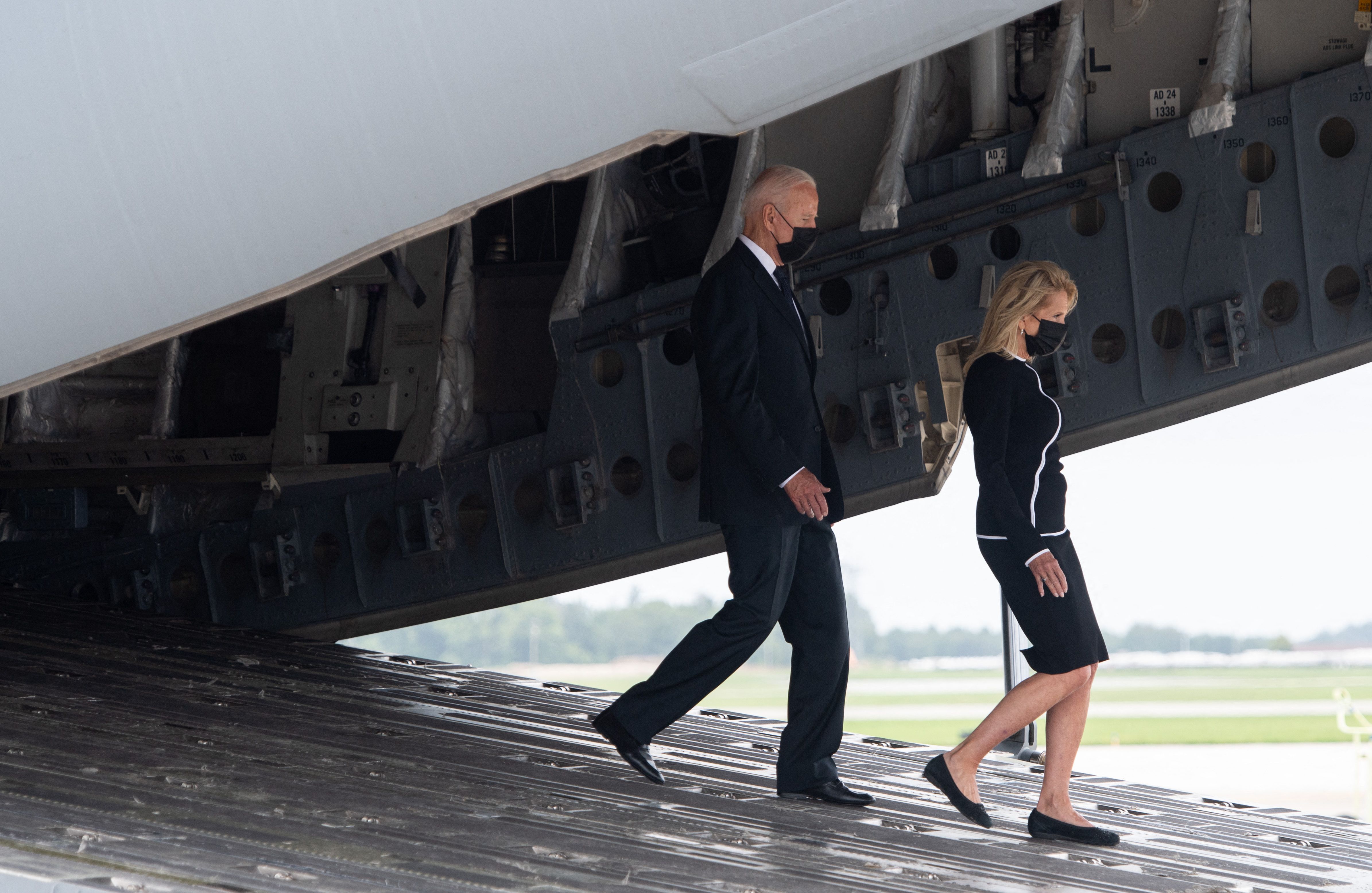 President Biden and first lady Jill Biden are seen leaving an Air Force transport plane after leading a prayer for the 13 service members killed in Kabul last week.