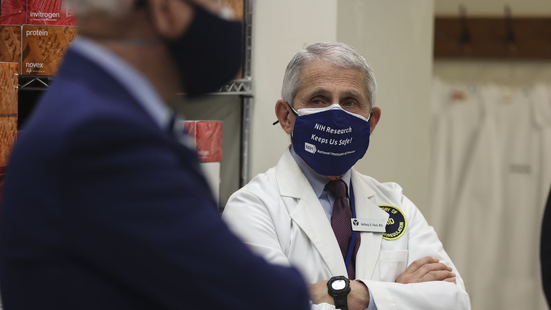 Photo of a masked Anthony Fauci standing with his arms crossed