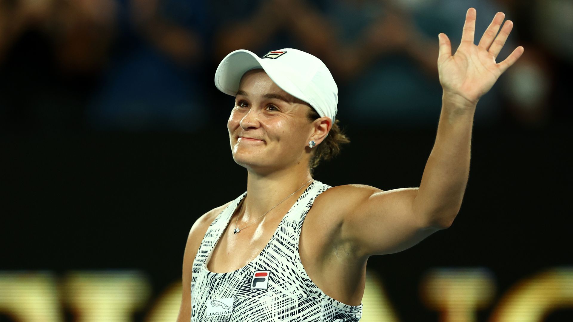 Ash Barty waves to the crowd after a match.