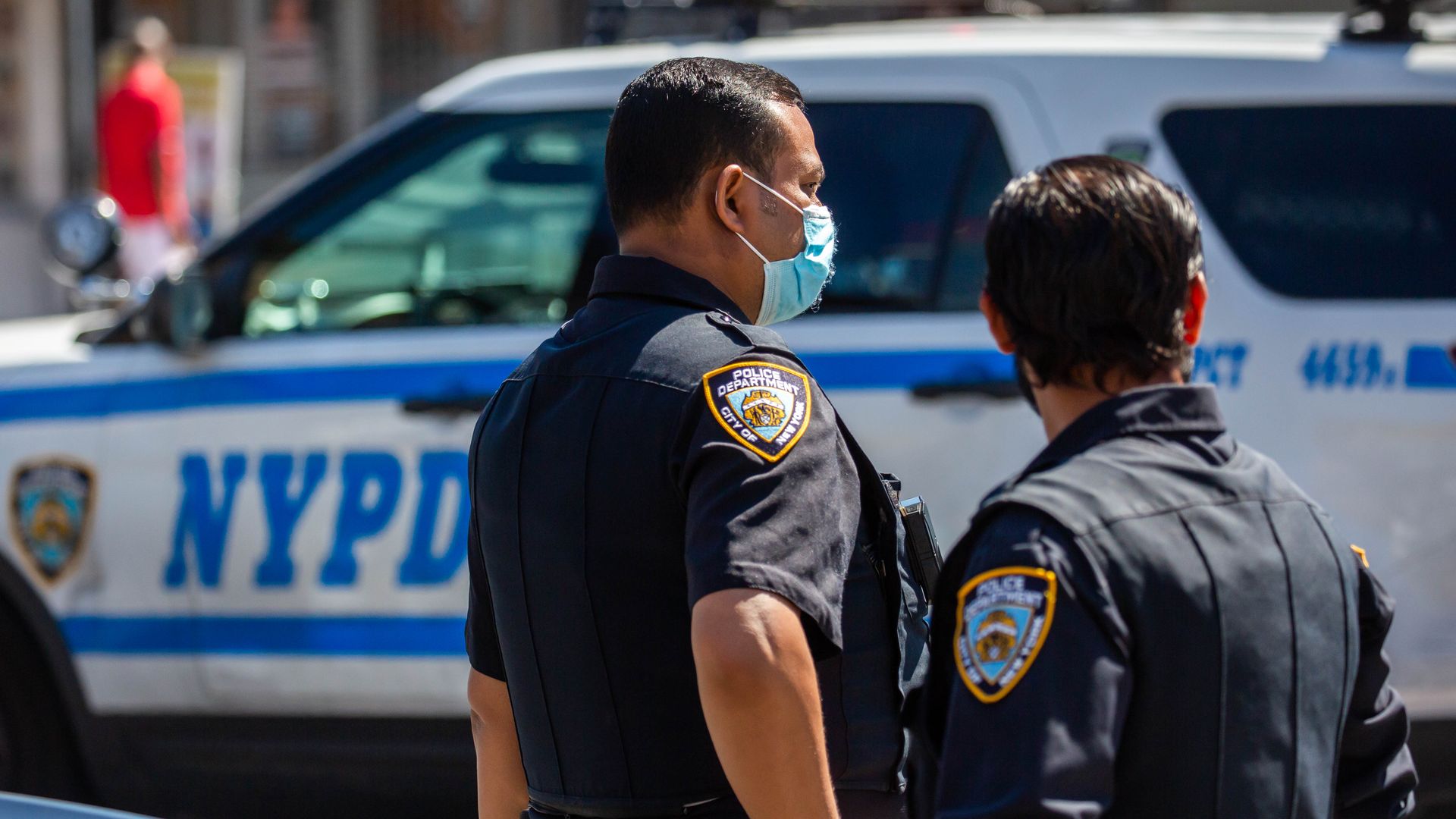 NYPD officers monitor a crime scene in the 73th precinct in the Brownsville neighborhood in the Brooklyn borough