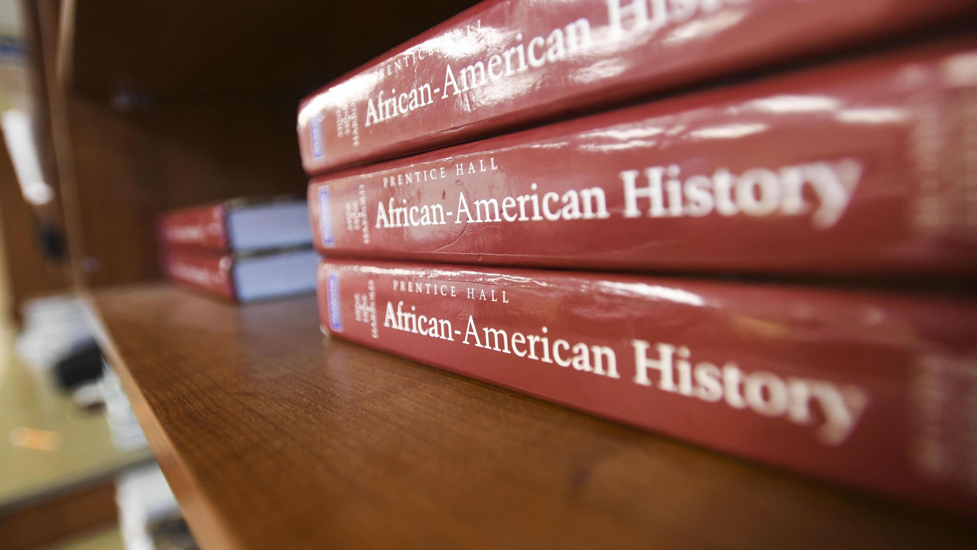 Photo of three red textbooks with the words "African-American History" printed on the binding. They are stacked on top of each other.