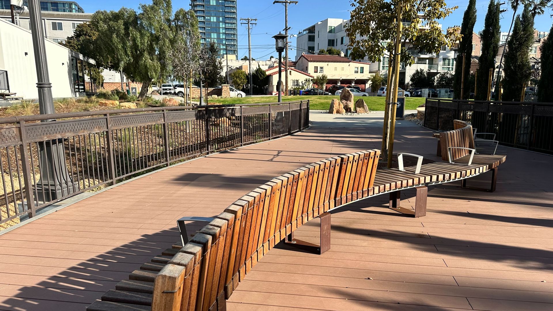 A wooden bench on an observation deck at a pocket park and AIDS Memorial in San Diego