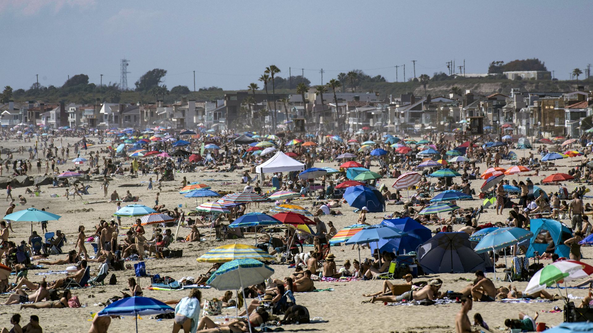 Large crowds gather near the Newport Beach Pier in Newport Beach on Saturday, April 25