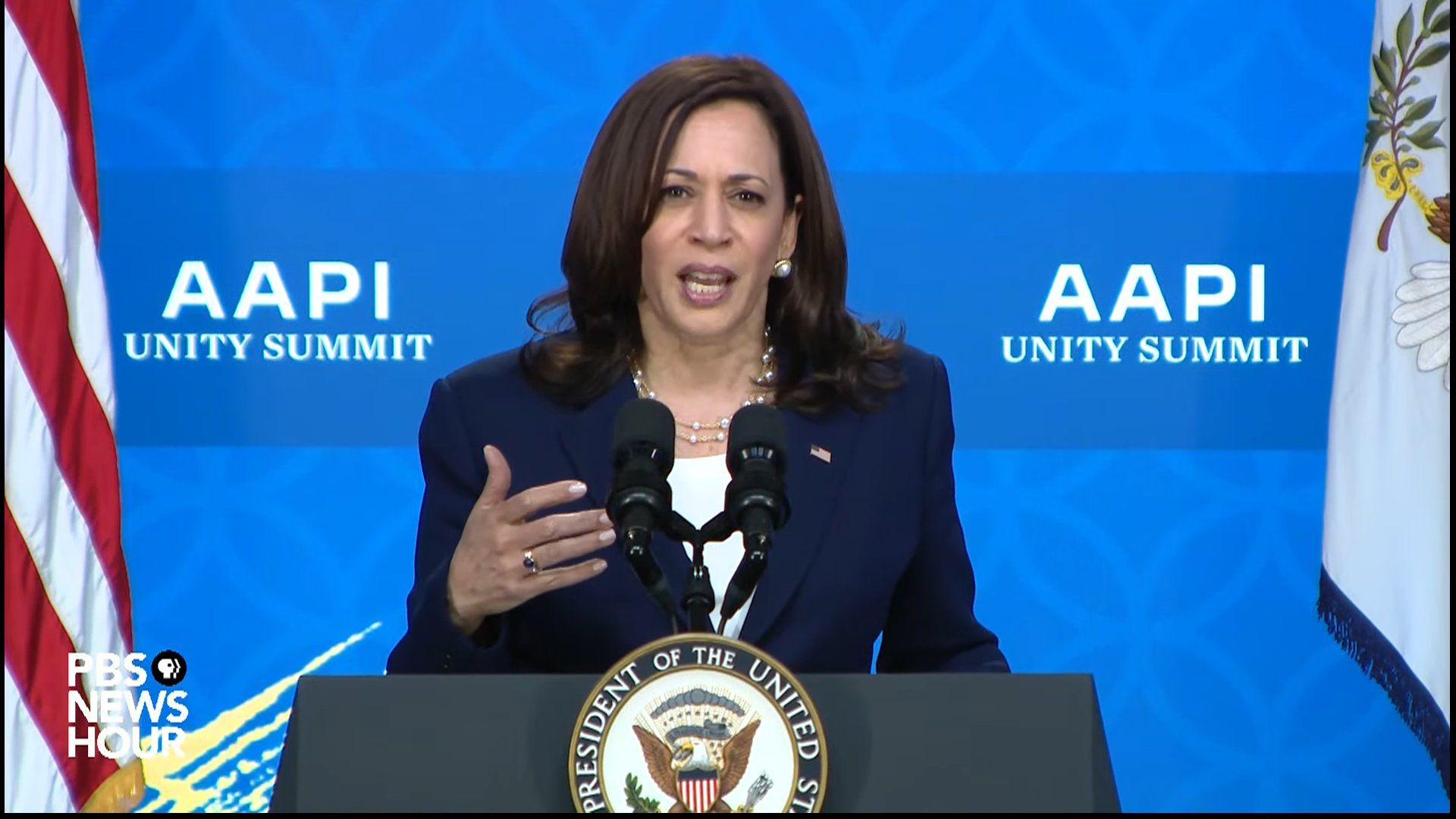 Screenshot of Kamala Harris speaking into a mic at the AAPI Unity Summit