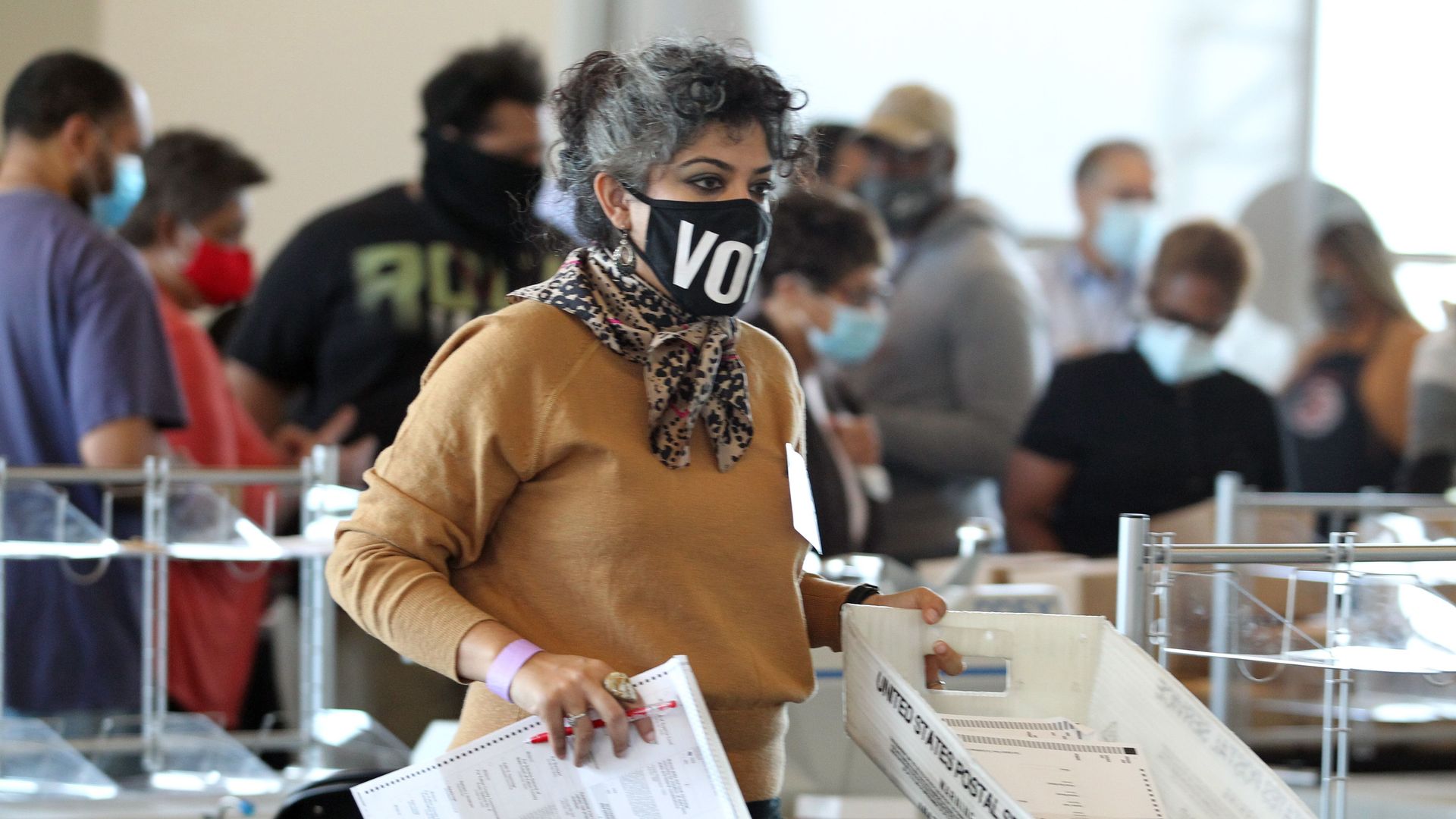 Fulton County election workers examine ballots while vote counting, at State Farm Arena on November 5, 2020, in Atlanta, Georgia.