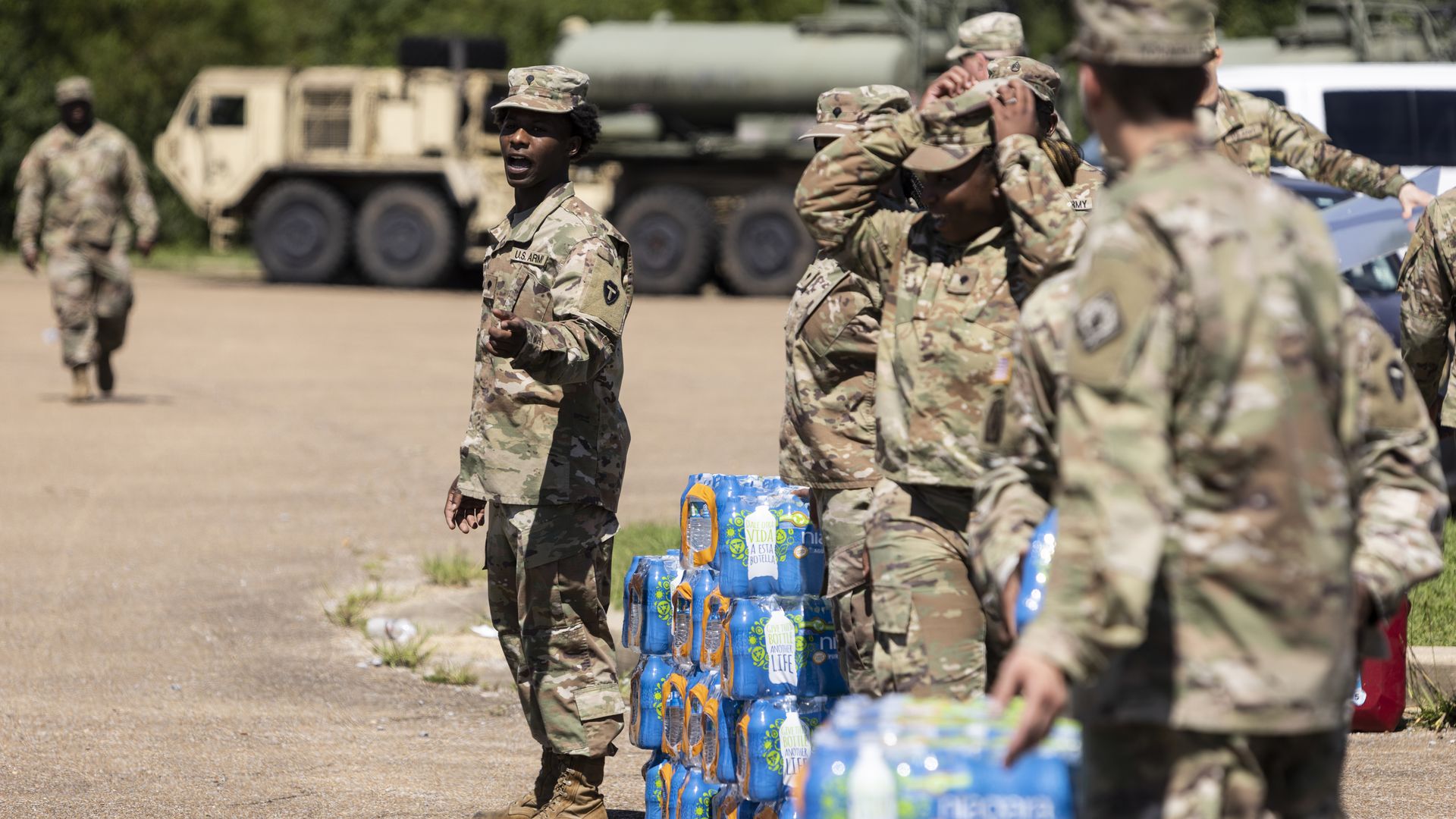 embers of the Mississippi National Guard hand out bottled water at Thomas Cardozo Middle School in response to the water crisis on September 01, 2022