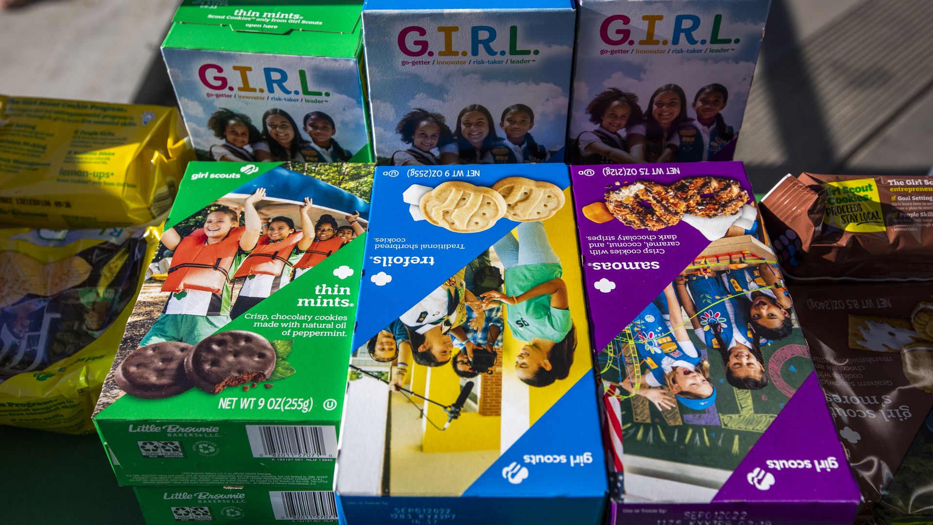 Girl Scout cookie boxes including Thin Mints, Trefoils and Samoas.