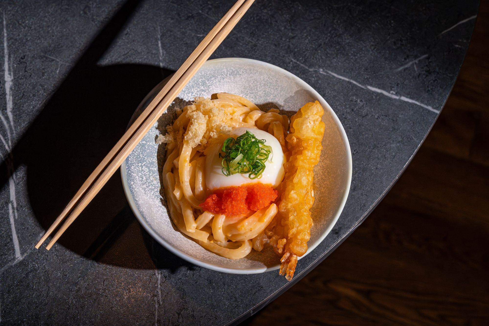 Creamy udon noodles with egg, roe and tempura shrimp