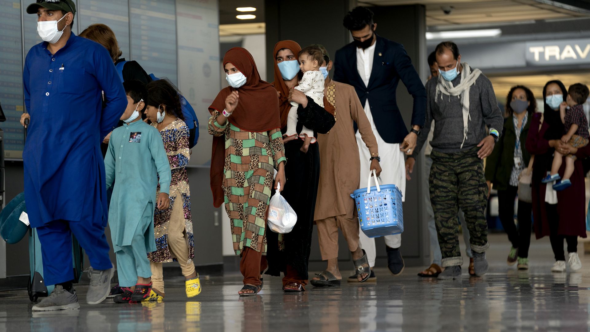 A line of refugees from Afghanistan walk through Washington Dulles International Airport