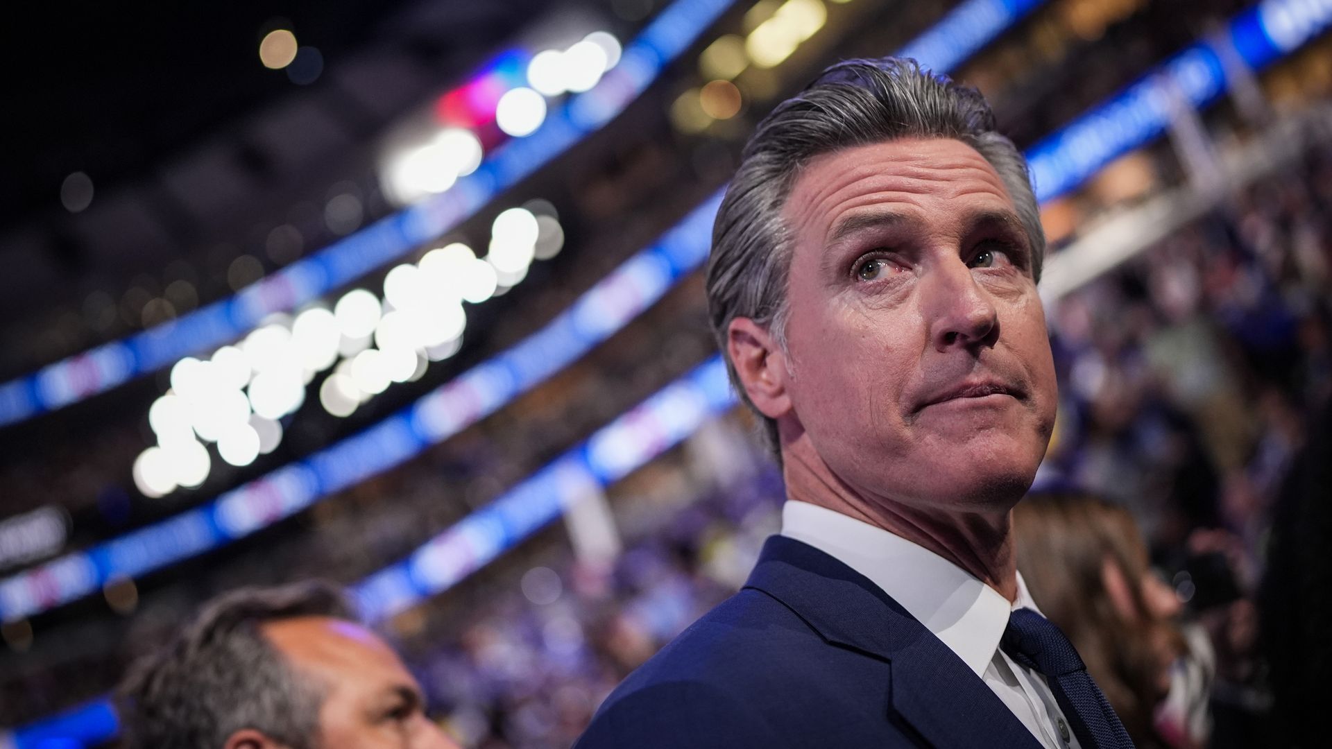 Photo of Gavin Newsom looking to his right in a crowded stadium
