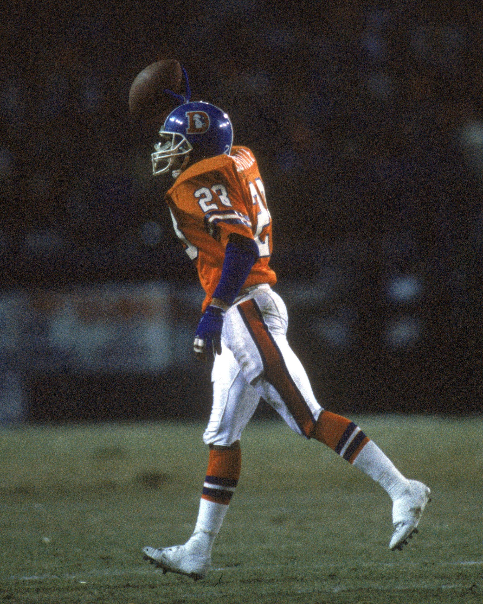 Broncos player holding a football