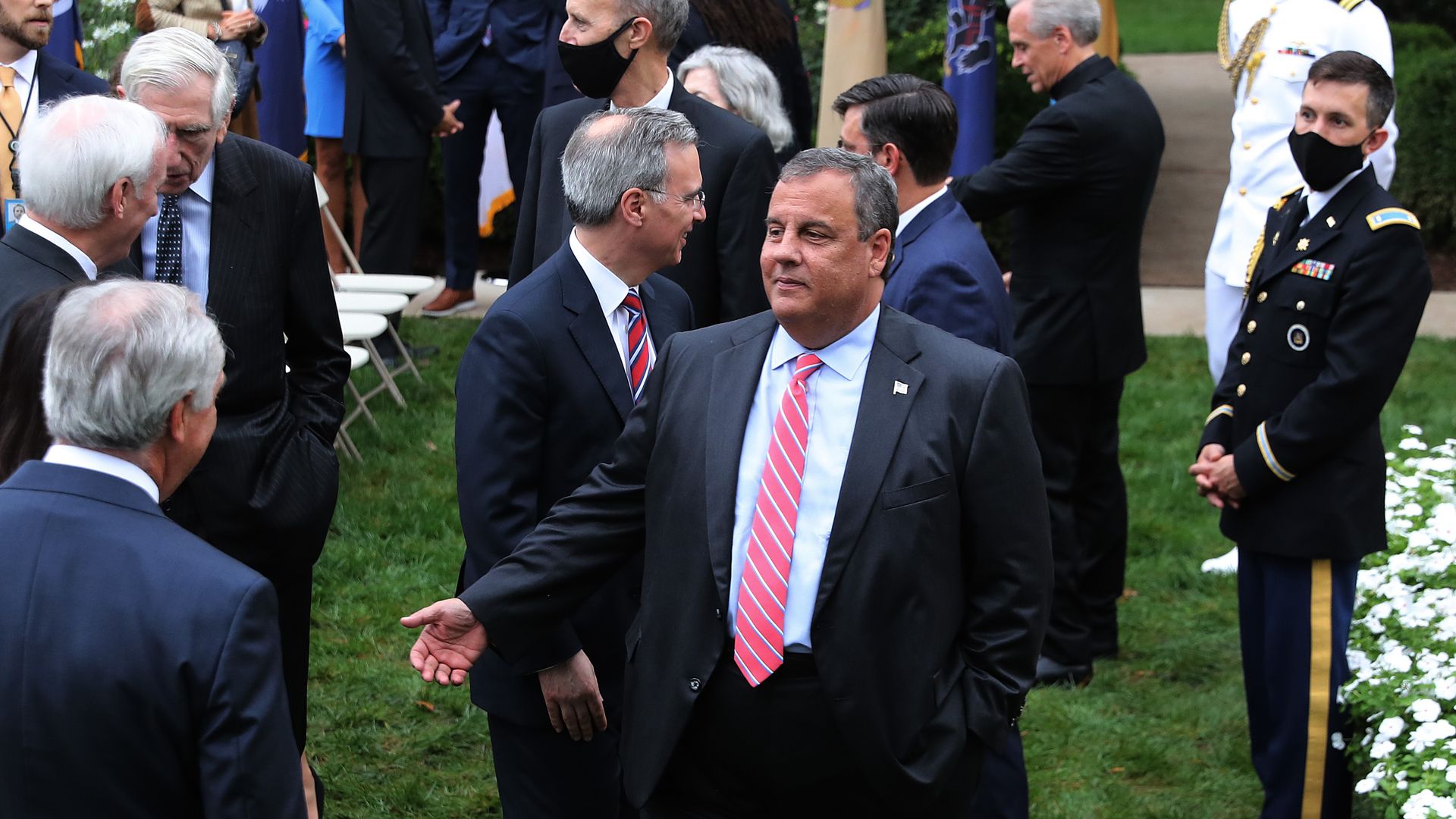 Former New Jersey Governor Chris Christie (C) talks with guests in the Rose Garden in September