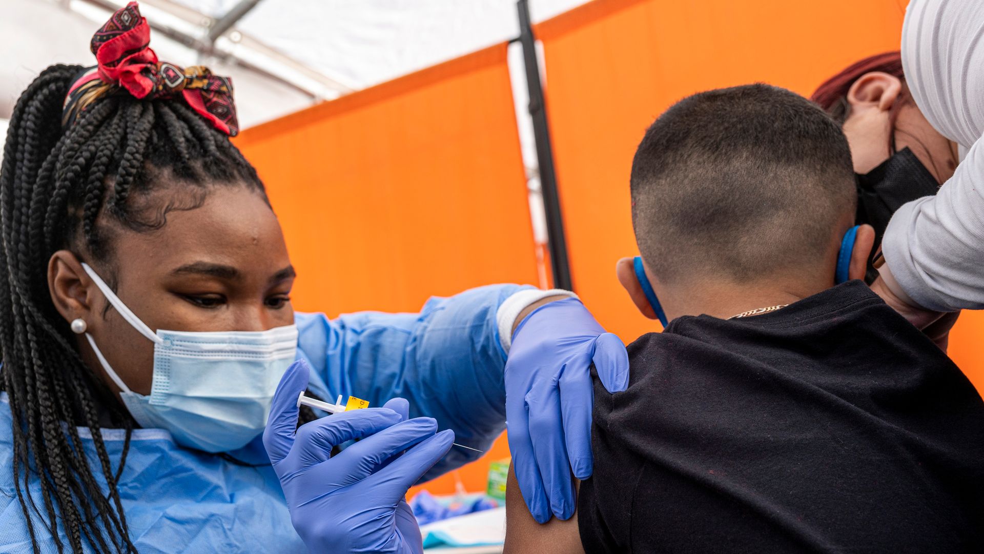 A healthcare worker administers a Pfizer-BioNTech Covid-19 vaccine to a child at a testing and vaccination site in San Francisco, California, U.S., on Monday, Jan. 10.