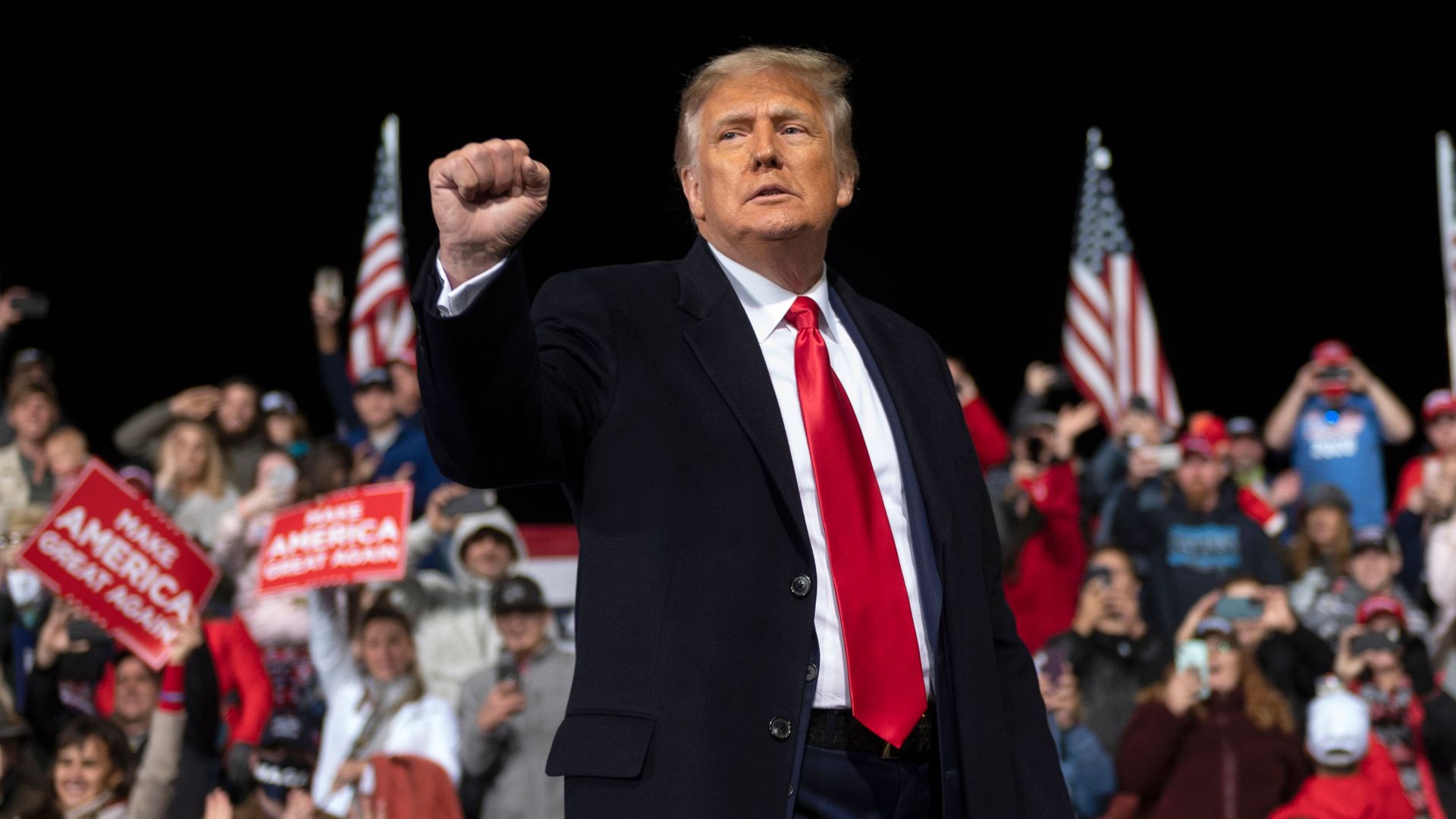 President Donald Trump holds up his fist as he leaves the stage at the end of a rally to support Republican Senate candidates at Valdosta Regional Airport in Valdosta, Georgia on December 5, 2020.