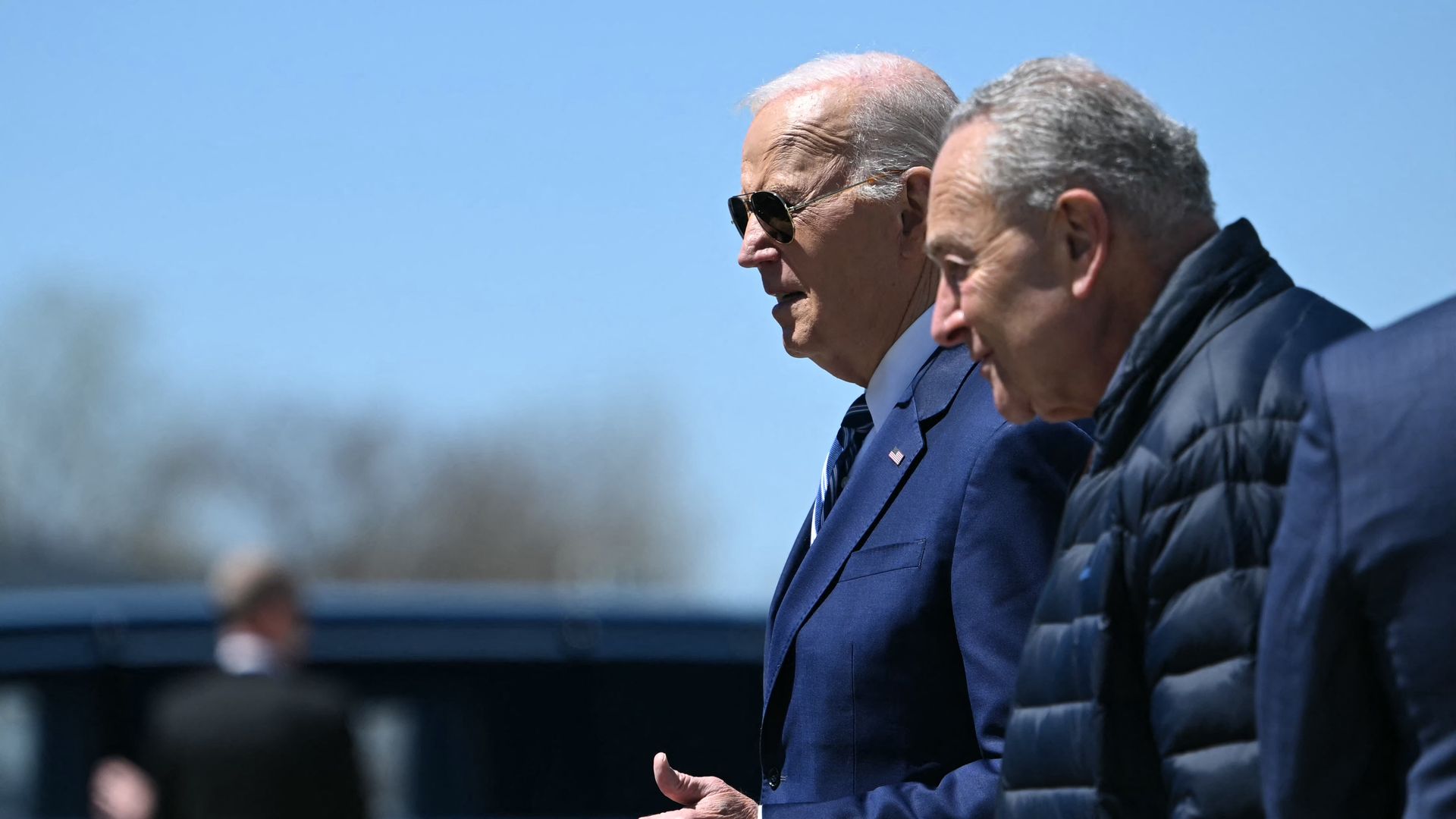 US President Joe Biden walks with US Senate Majority Leader Chuck Schumer upon arrival at Hancock Field Air National Guard Base in Syracuse, New York